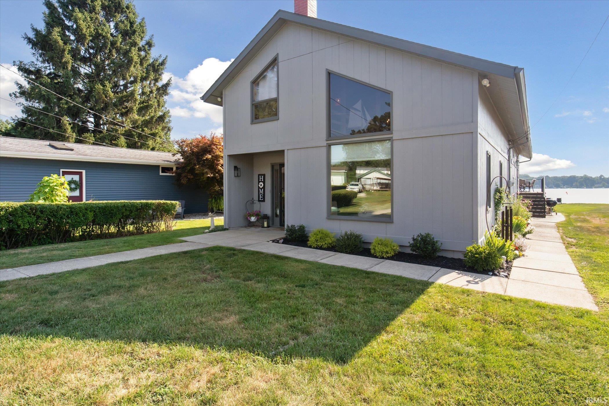 Image 1: View of front facade featuring a front yard and a chimney, Front Of Structure