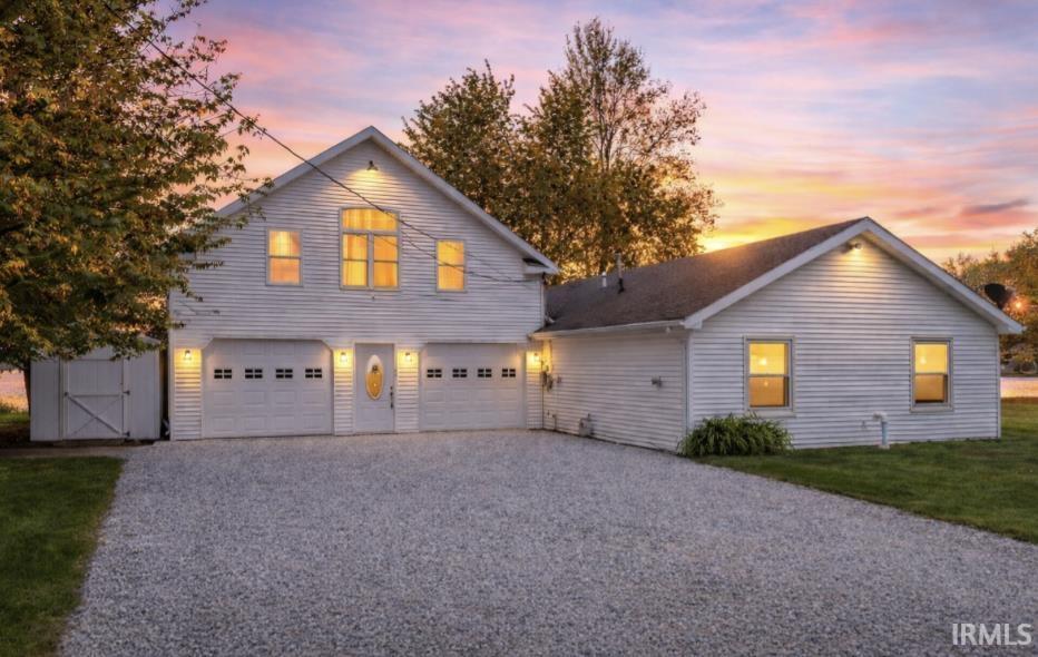 Image 0: View of front of home featuring driveway, a garage, and a front lawn, Front Of Structure