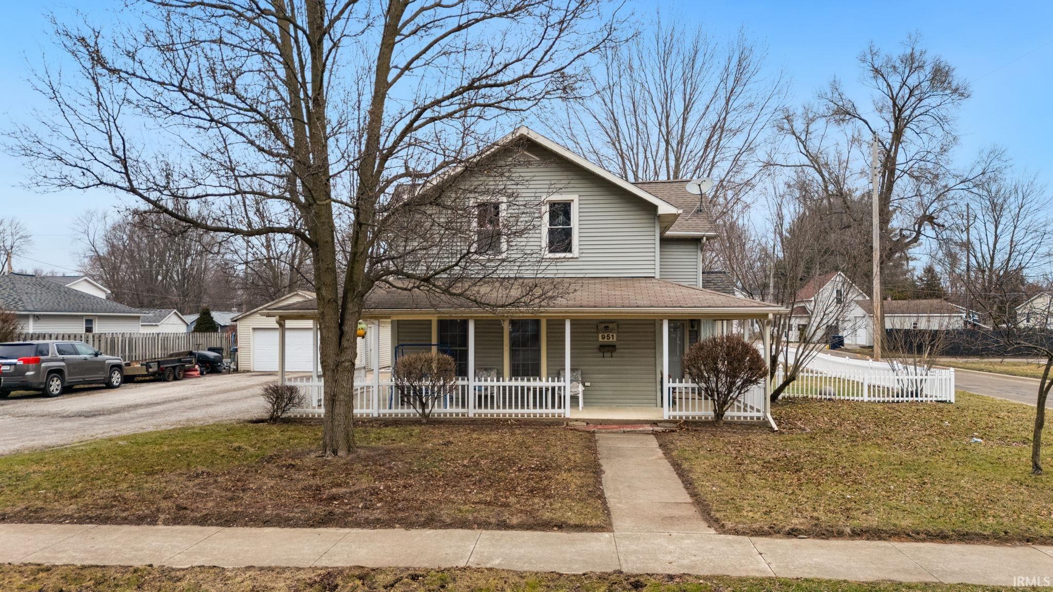 Image 3: Farmhouse inspired home with a porch, a shingled roof, a garage, and driveway, Front Of Structure