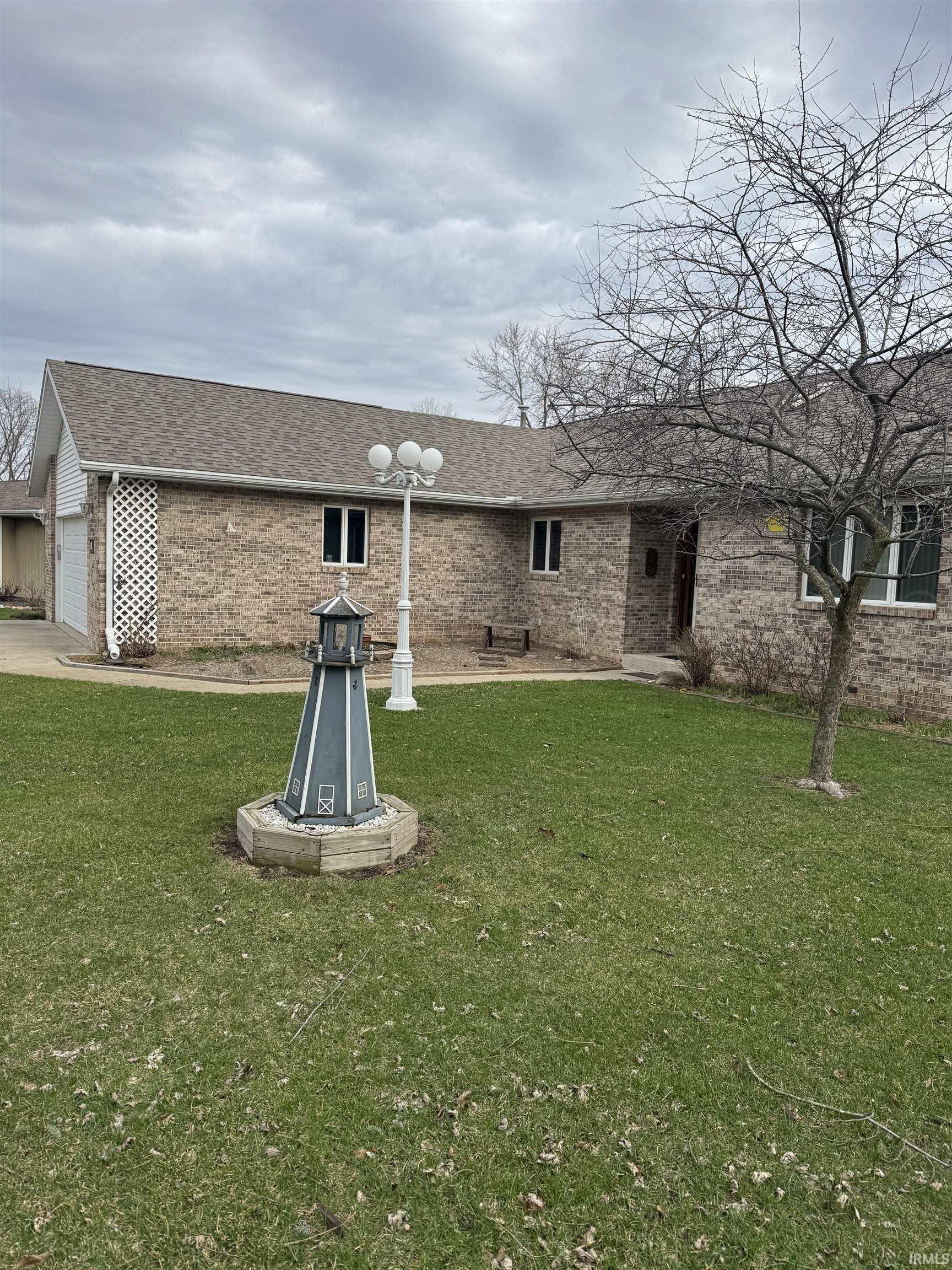 Image 3: Rear view of property featuring roof with shingles, brick siding, and a yard, Back Of Structure Image 3: Rear view of property featuring roof with shingles, brick siding, and a yard, Back Of Structure