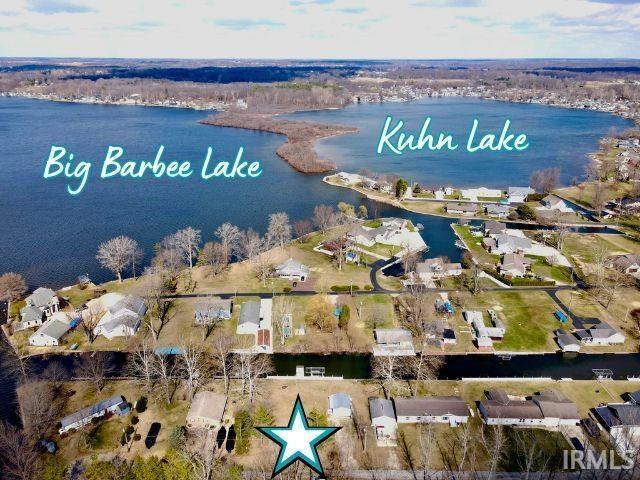Image 0: Aerial perspective of suburban area with a nearby body of water, Aerial View