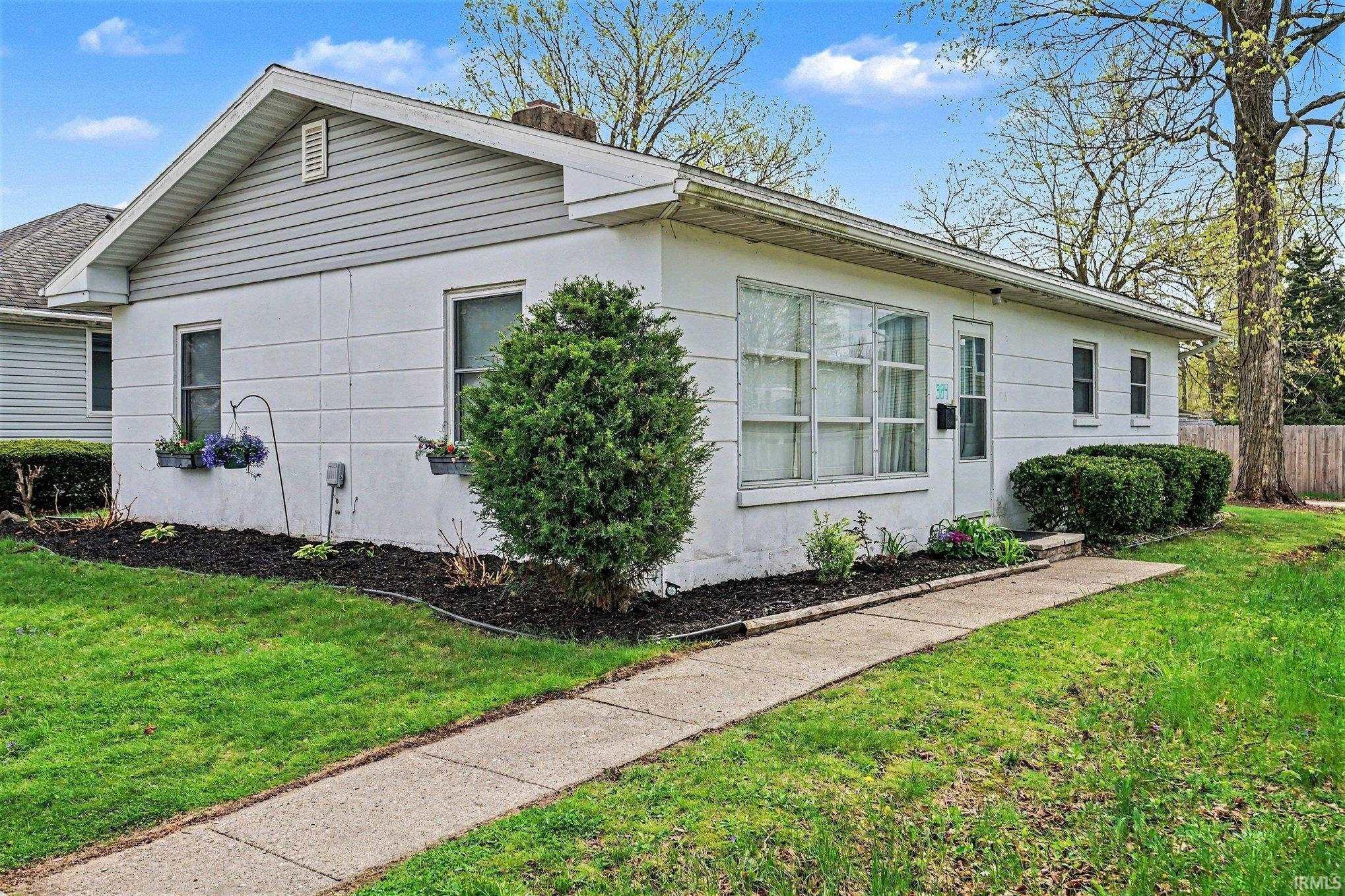 Image 0: View of side of home featuring stucco siding and a chimney, Side Of Structure