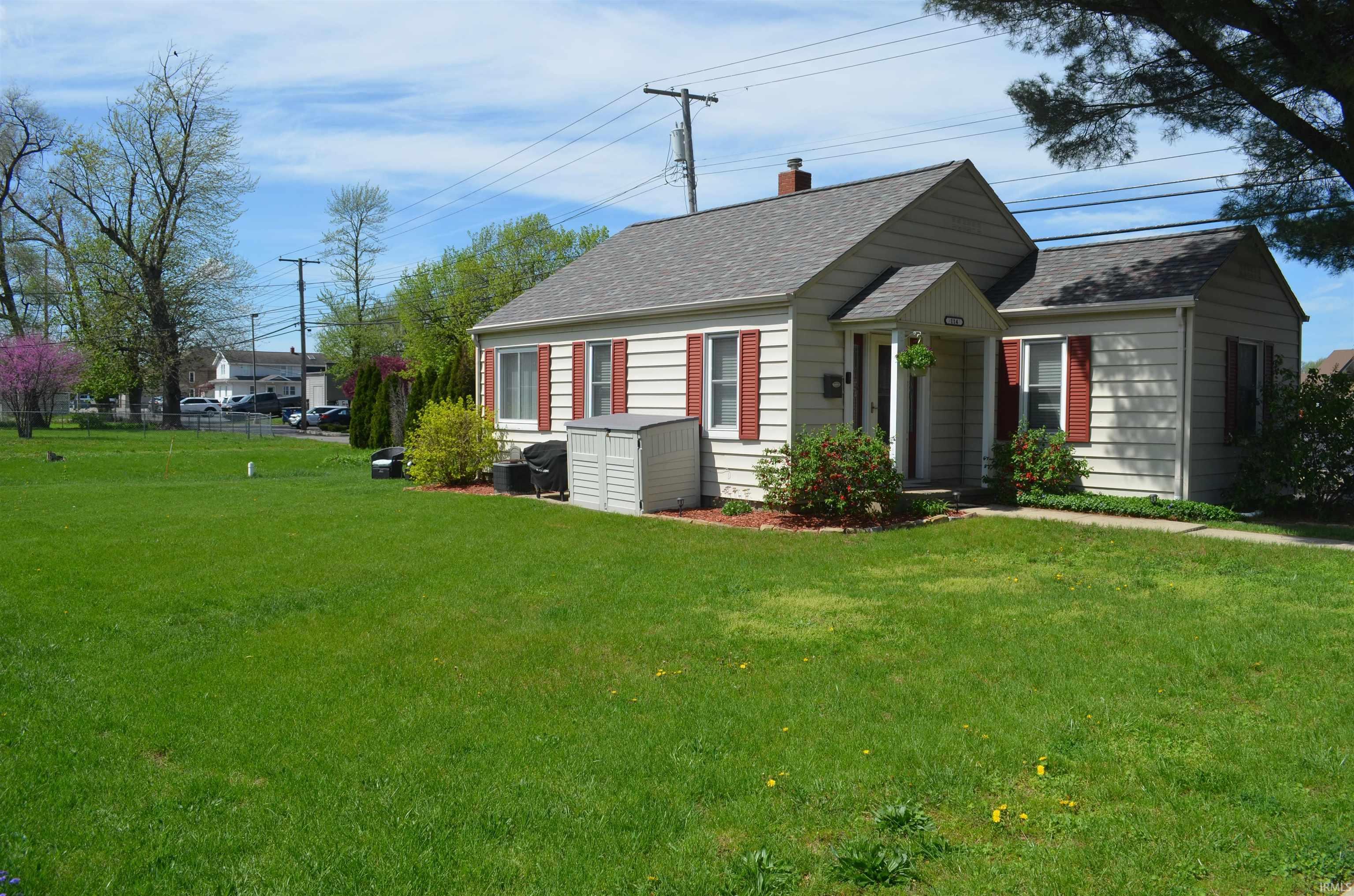 Image 0: Traditional-style home featuring light-colored siding, a gray shingle roof, and red shutters, Front Of Structure Image 0: Traditional-style home featuring light-colored siding, a gray shingle roof, and red shutters, Front Of Structure