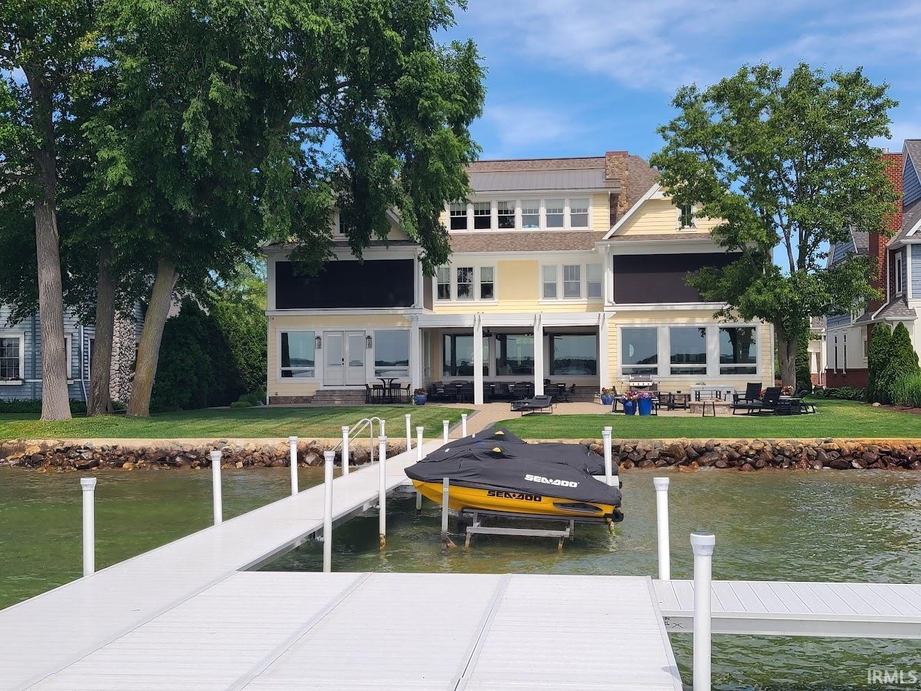 Image 0: Waterfront property featuring a private dock with personal watercraft lift, Back Of Structure Image 0: Waterfront property featuring a private dock with personal watercraft lift, Back Of Structure