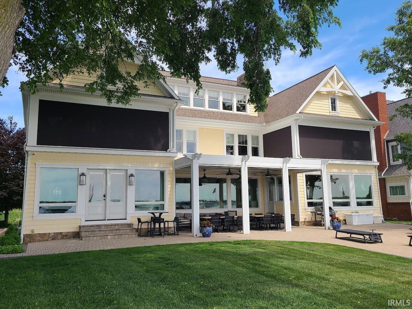 Image 2: Expansive exterior with light yellow siding and multiple gables, Back Of Structure Image 2: Expansive exterior with light yellow siding and multiple gables, Back Of Structure