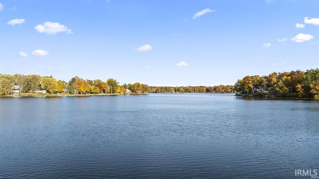 Image 2: Water view featuring a heavily wooded area, View