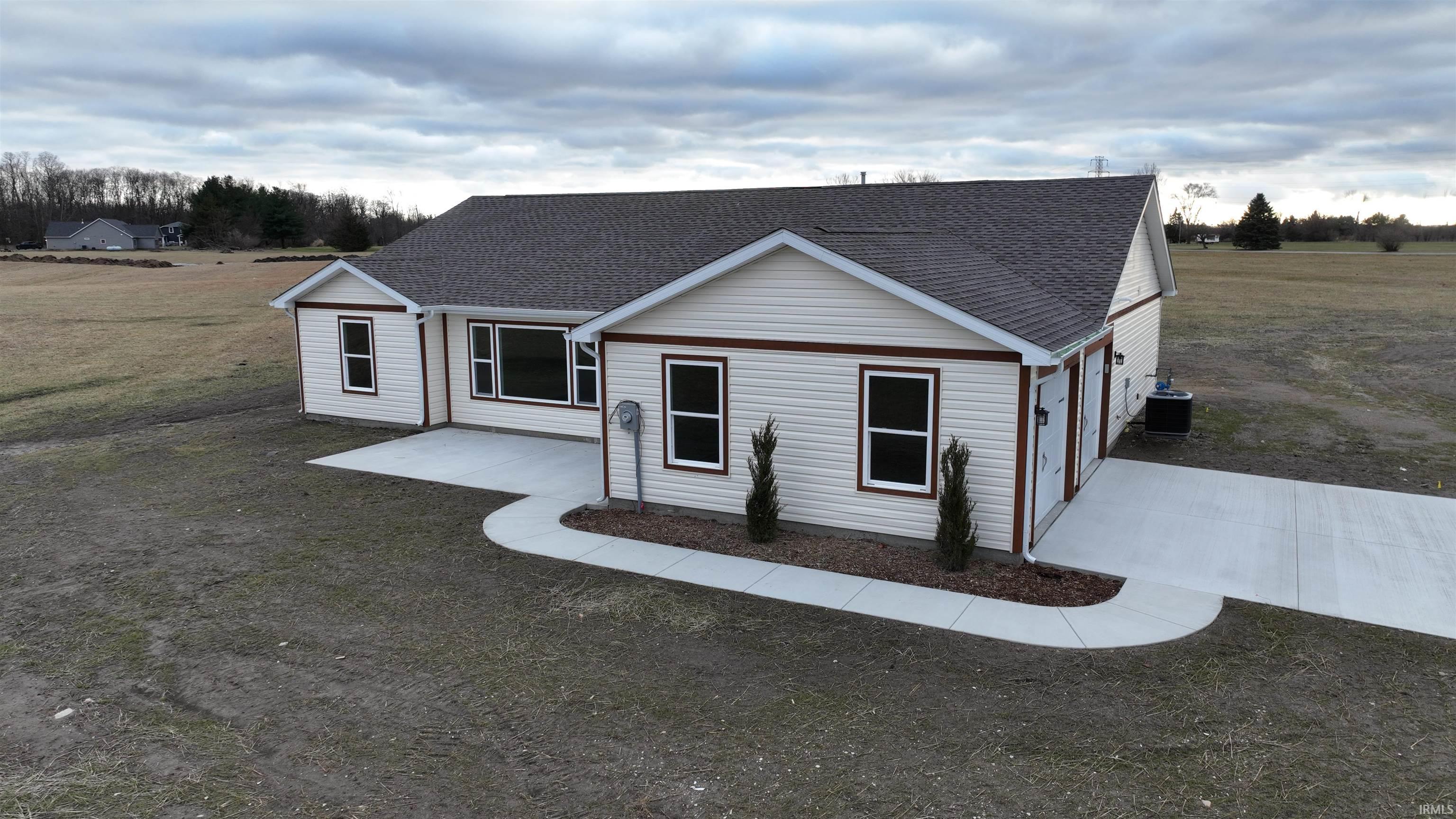 Image 2: Ranch-style home with a shingled roof and a front lawn, Front Of Structure