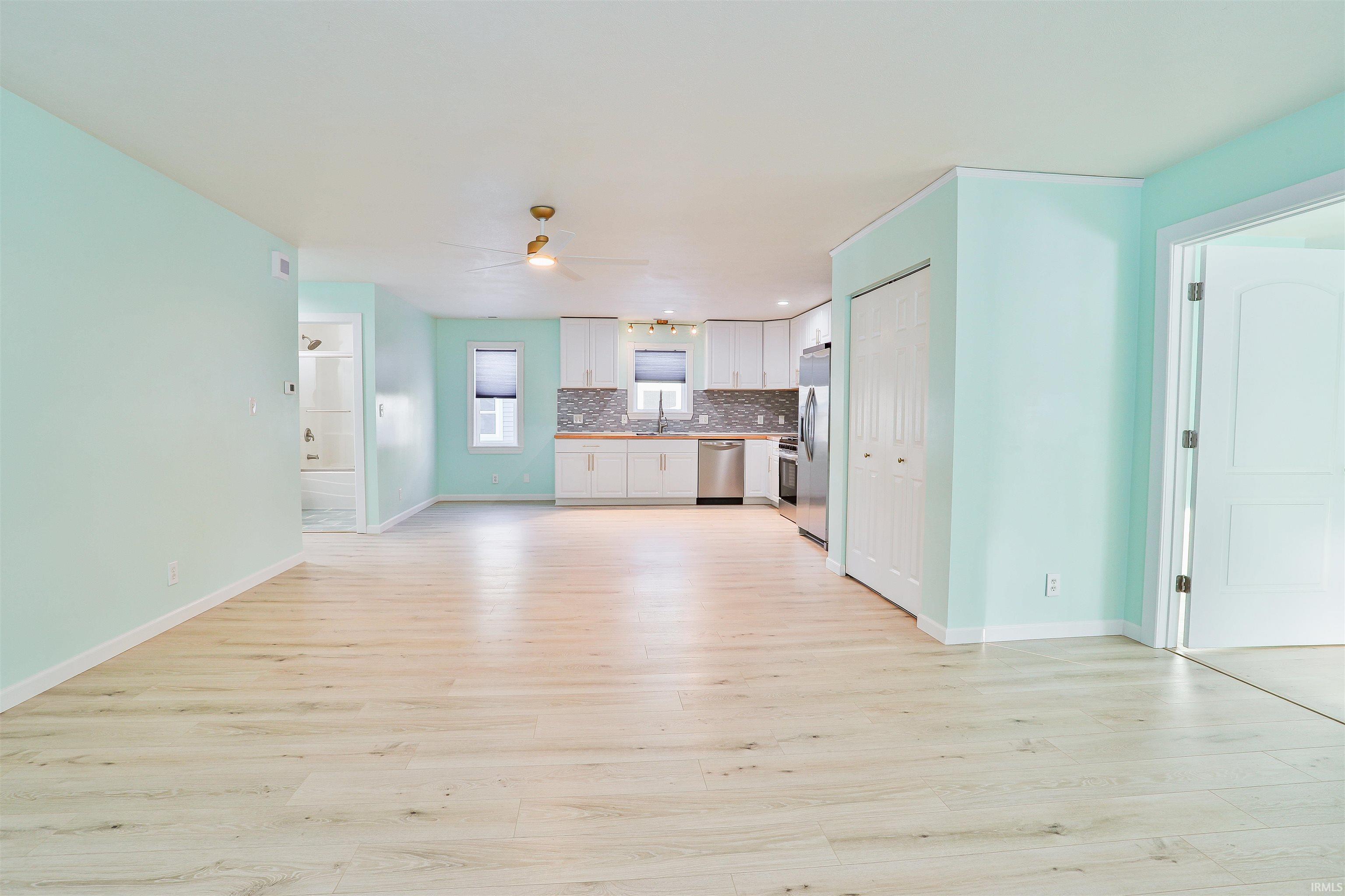 Image 3: Unfurnished living room featuring light wood-type flooring and a ceiling fan, Living Room