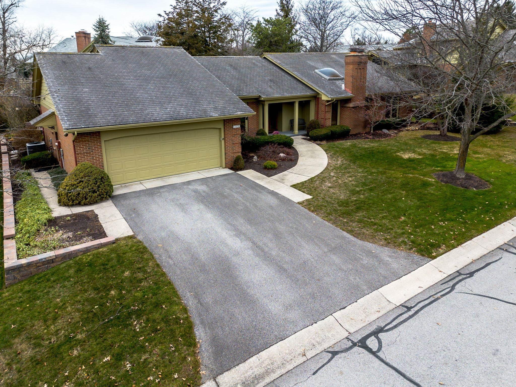 Image 2: Single story home with a front lawn, driveway, brick siding, a shingled roof, and a chimney, Front Of Structure
