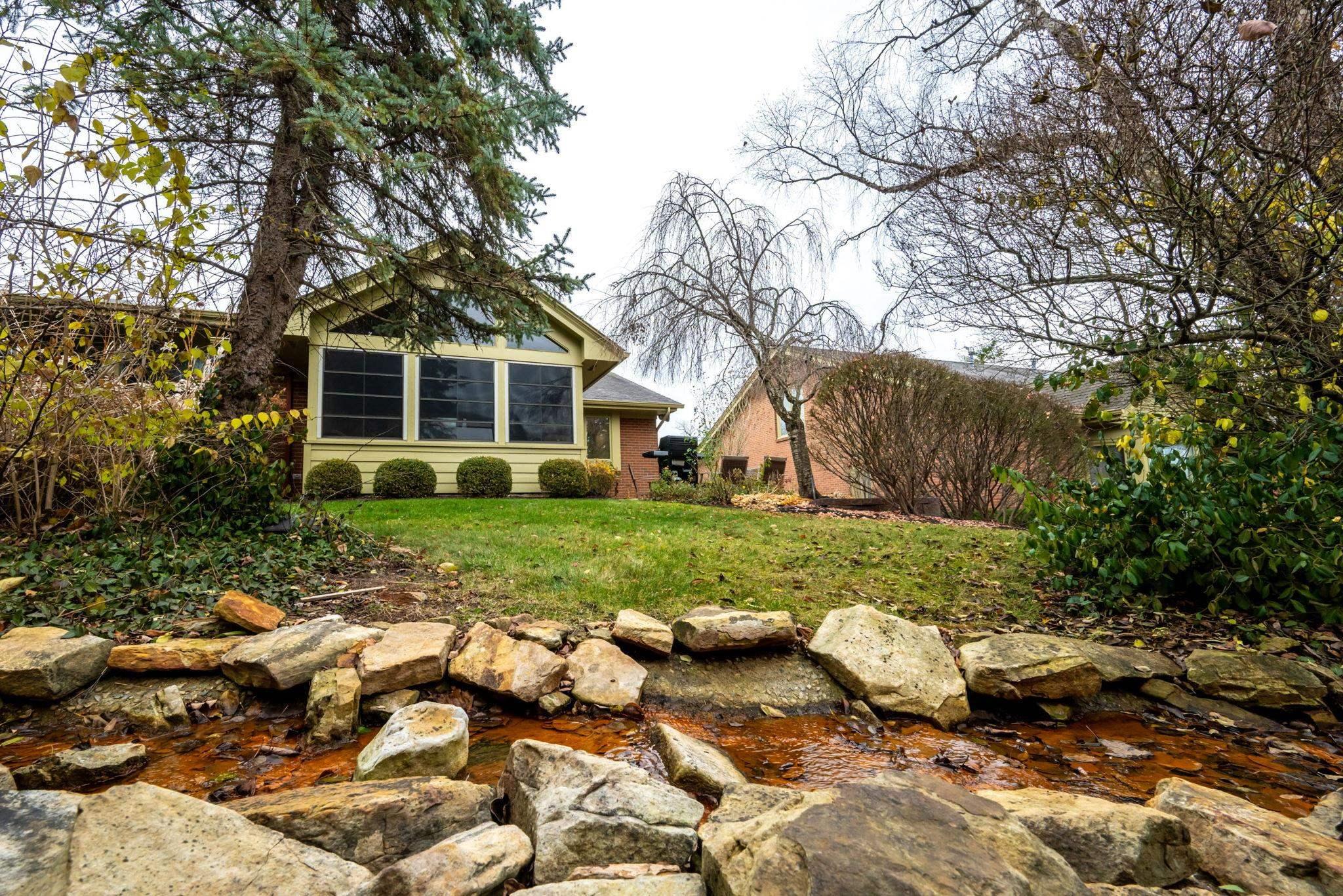 Image 3: View of grassy yard featuring a sunroom, Yard