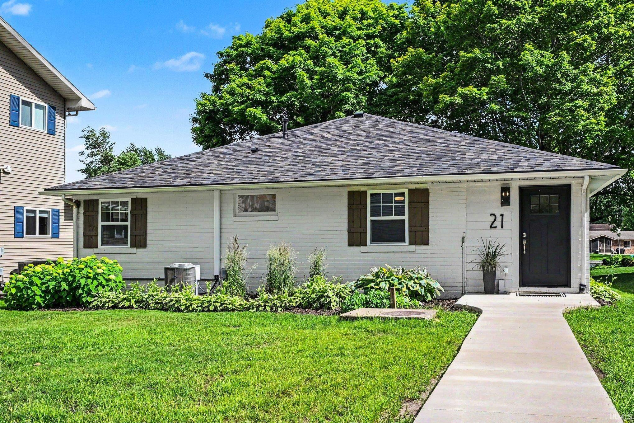 Image 1: White brick exterior with all new landscaping and new roof and windows., Roadside View Image 1: White brick exterior with all new landscaping and new roof and windows., Roadside View