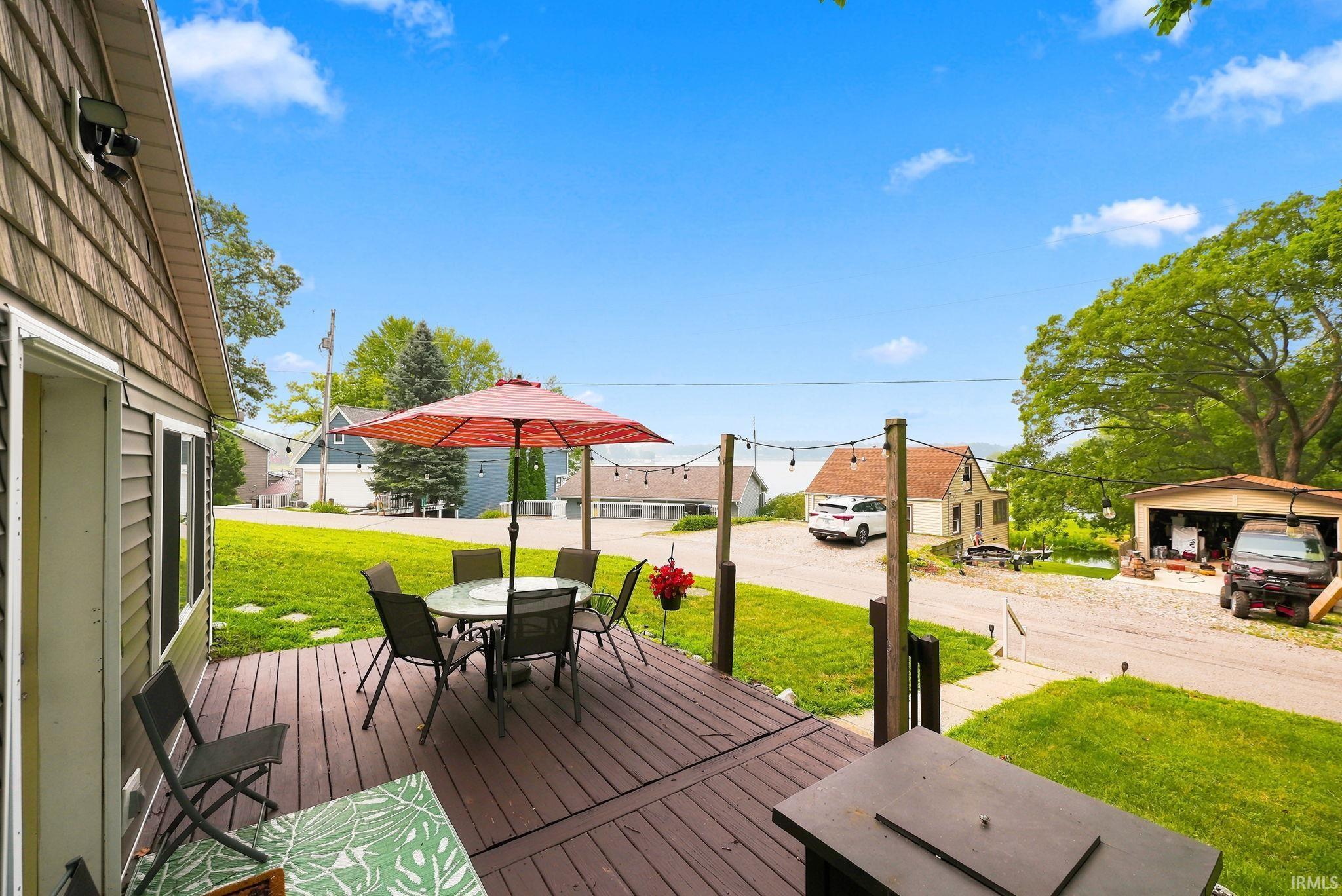 Image 2: Wood-finish decking extends from the residence, providing an outdoor living area, Deck