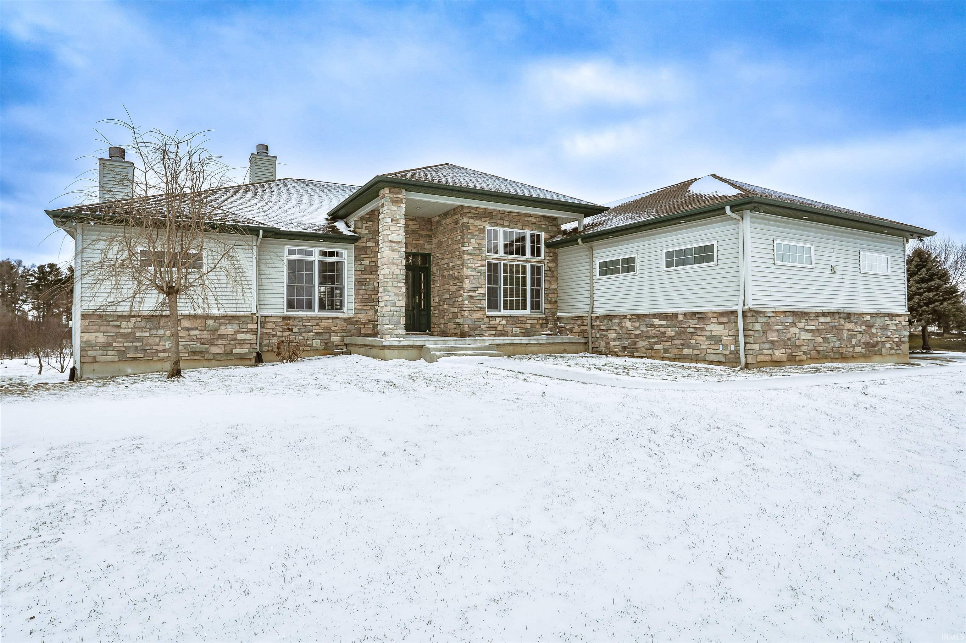 Image 3: View of front facade with stone siding and a chimney, Front Of Structure