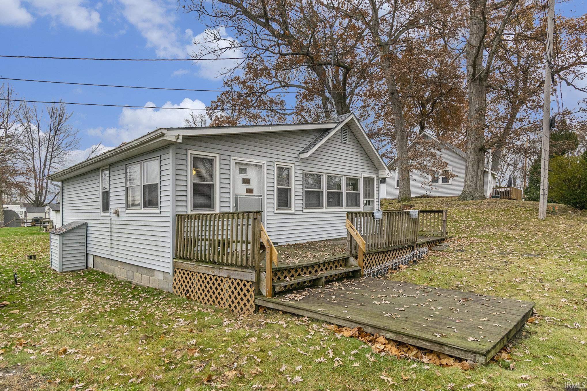 Image 1: Relax on the deck with partial view of the lake, Front/Side of House