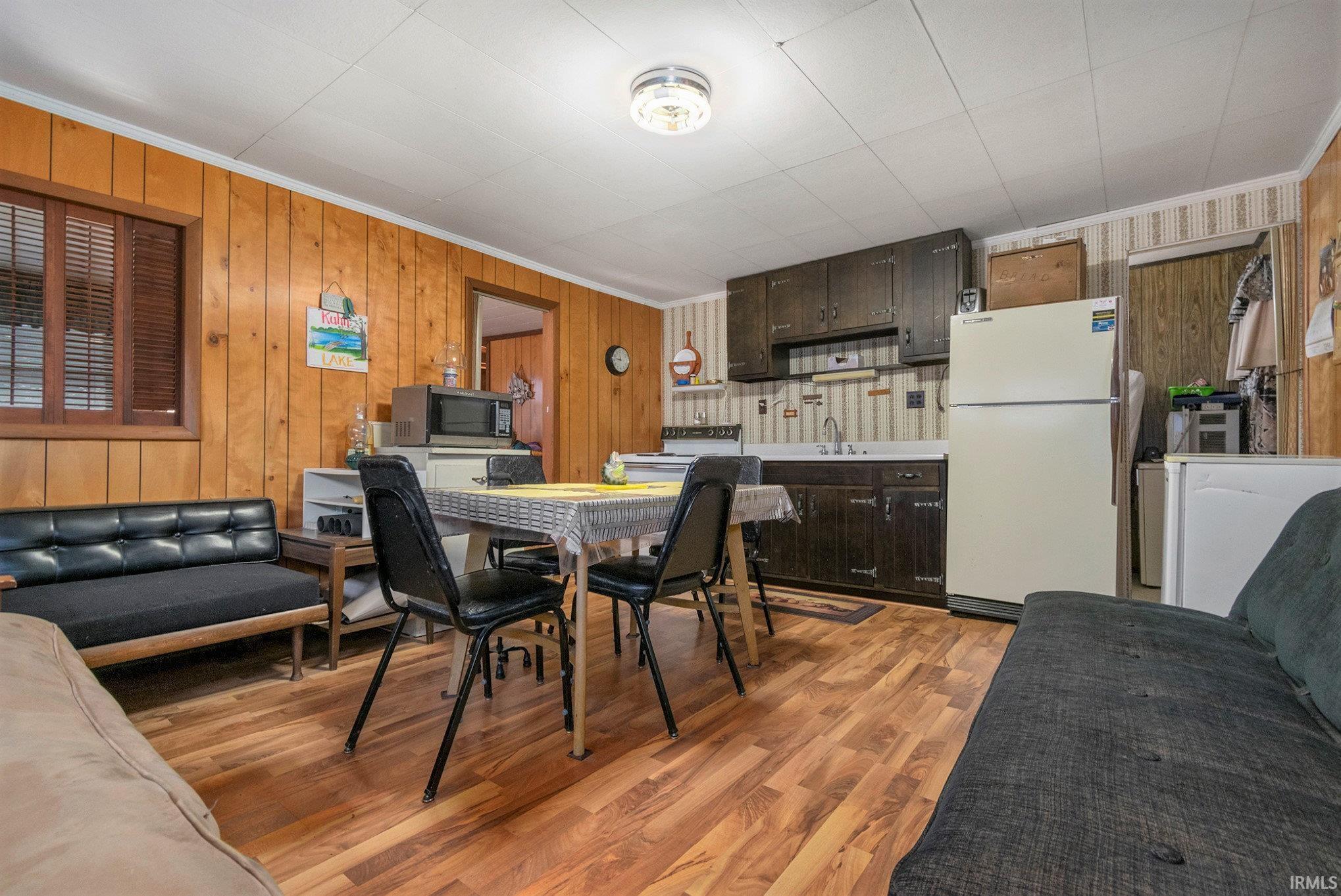 Image 2: This open kitchen/dining space has additional furniture around the perimeter that has been used through the years to accommodate numerous people for extended stays., Open Kitchen and Dining