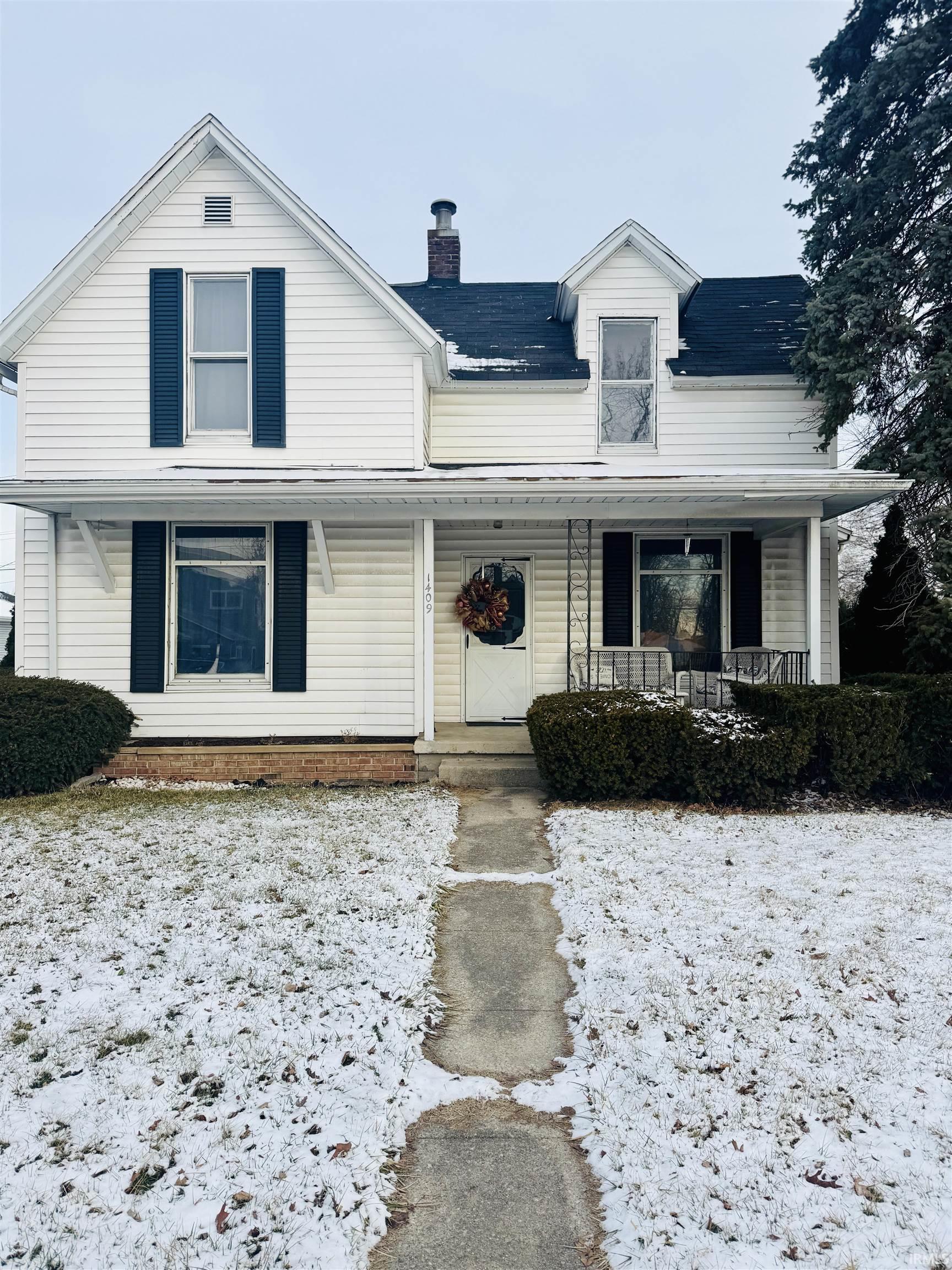 Image 0: View of front of property featuring covered porch and a chimney, Front Of Structure