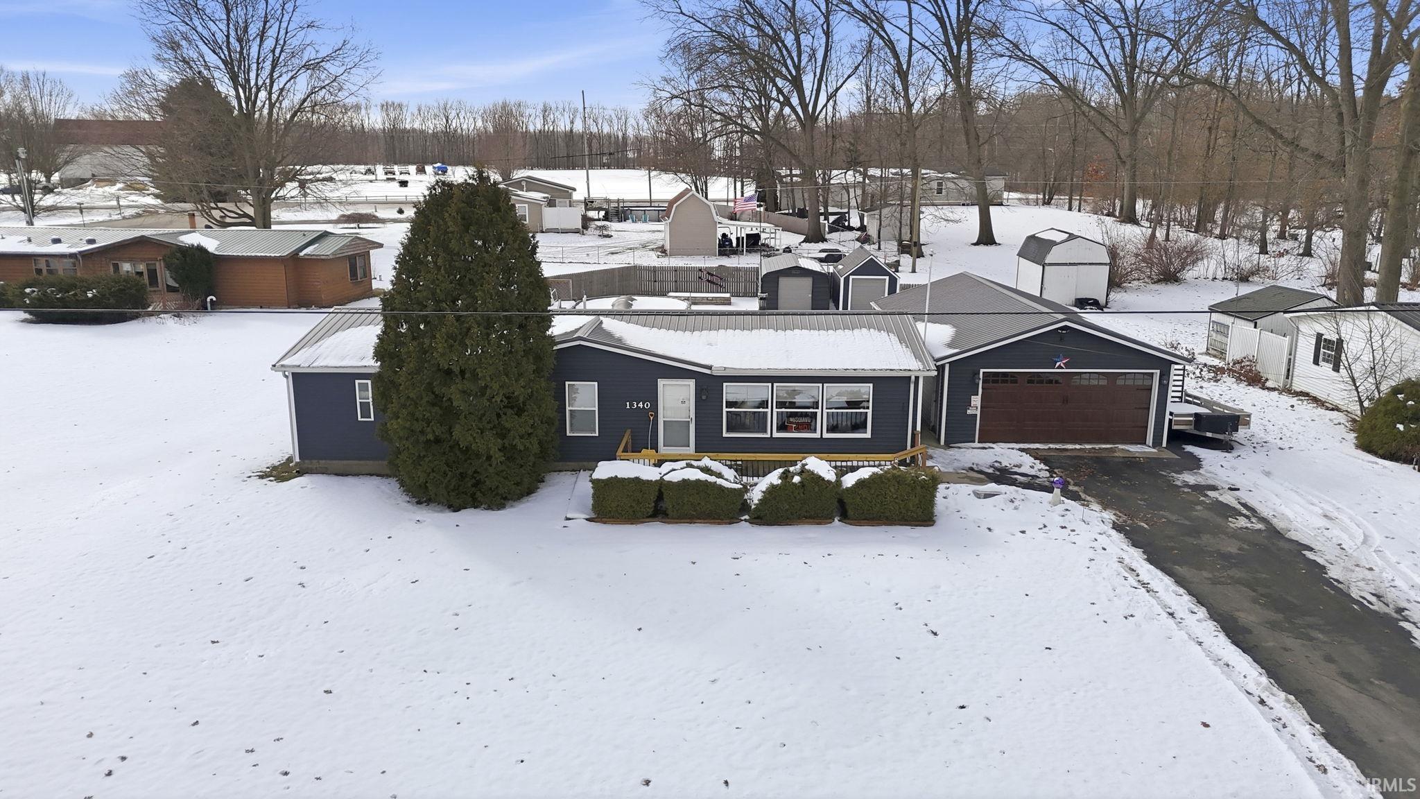 Image 1: View of front of property featuring an attached garage, Front Of Structure