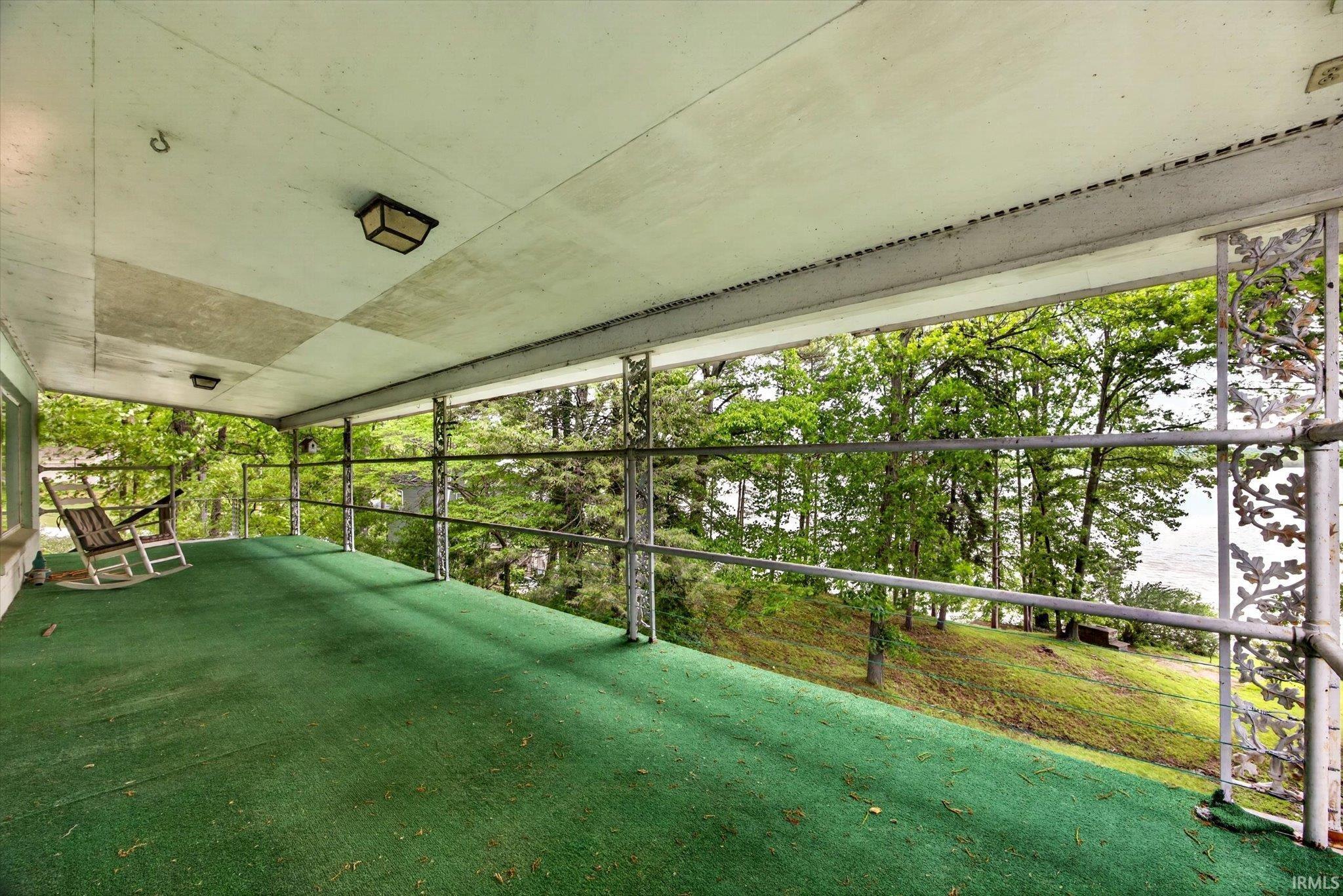 Image 2: Covered porch with green outdoor carpeting, Sun Room Image 2: Covered porch with green outdoor carpeting, Sun Room