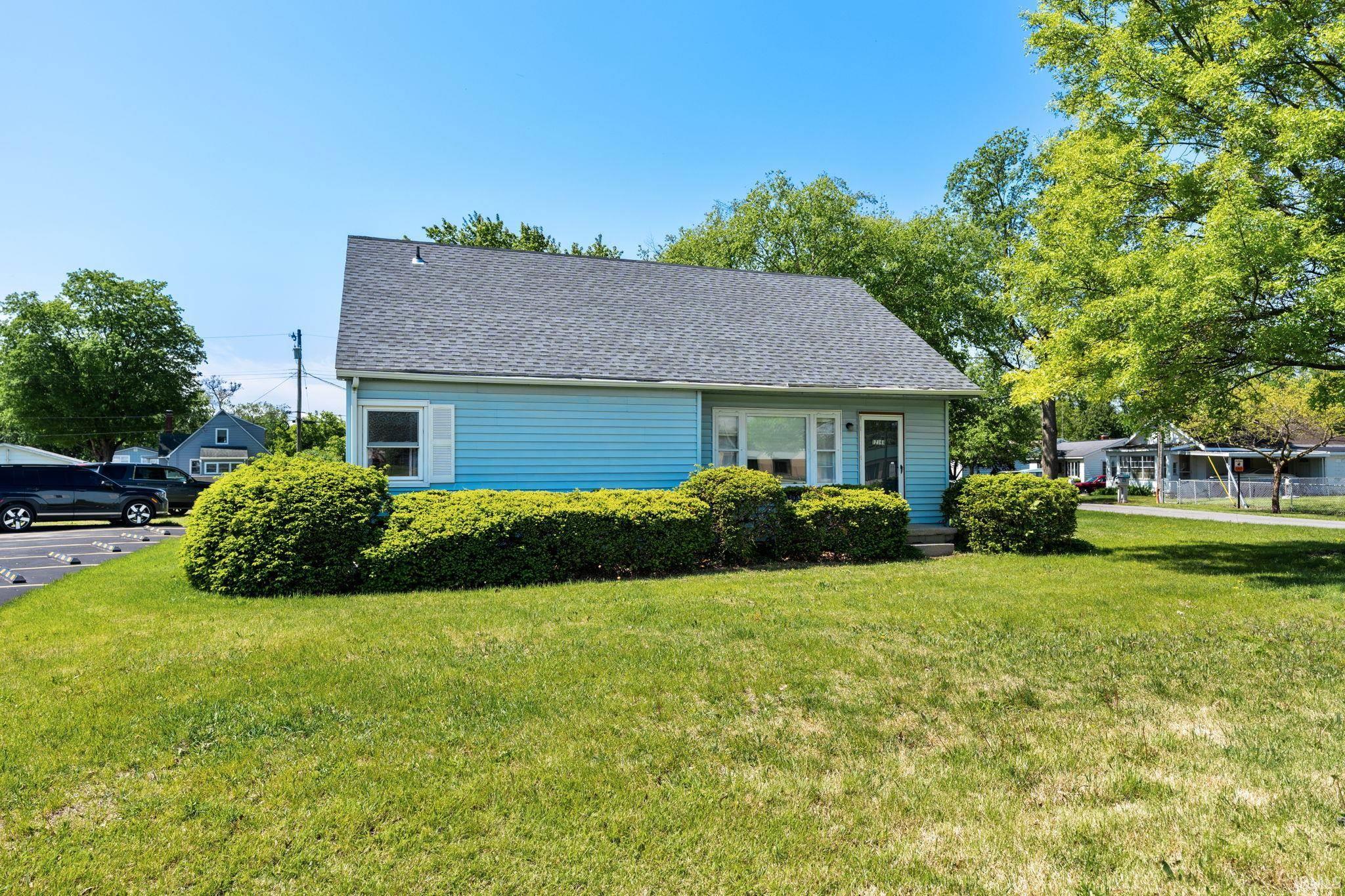Image 3: Light blue siding exterior with white window trim and shutters, complemented by a dark shingle roof, Side Of Structure Image 3: Light blue siding exterior with white window trim and shutters, complemented by a dark shingle roof, Side Of Structure