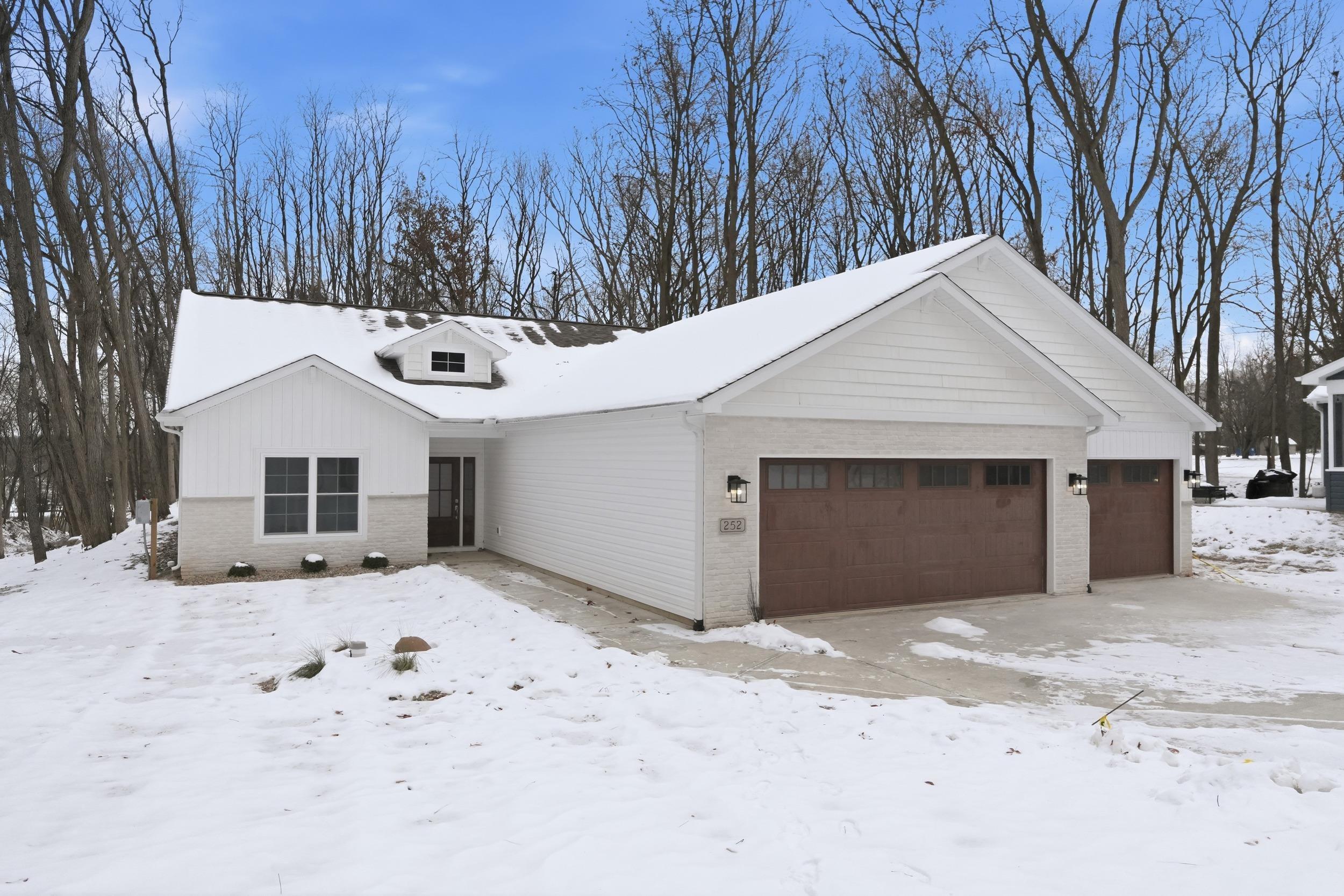 Image 0: View of front facade featuring brick siding and an attached garage, Front Of Structure