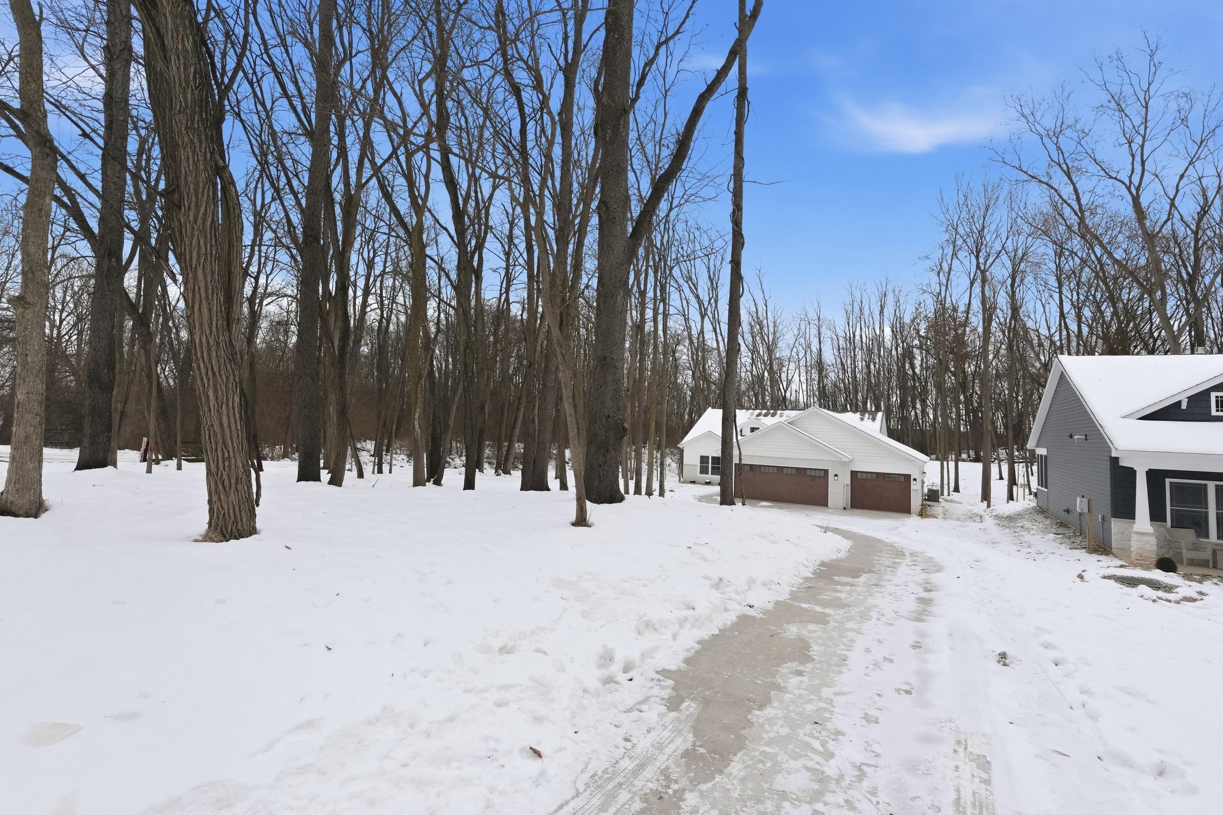 Image 2: Snowy yard with a detached garage and an outbuilding, Yard