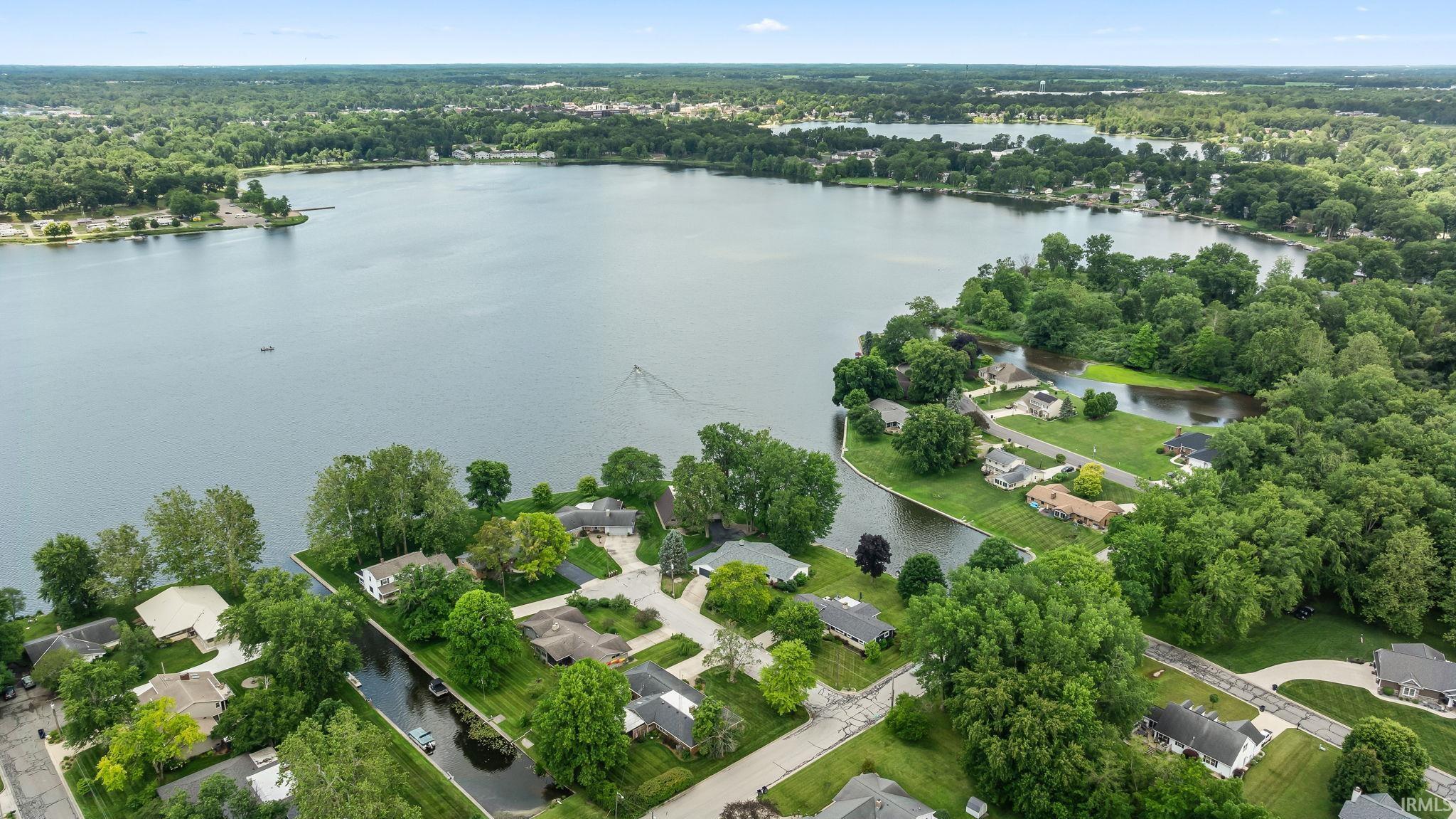 Image 1: Expansive freshwater lake with surrounding residential properties and mature trees, Aerial View