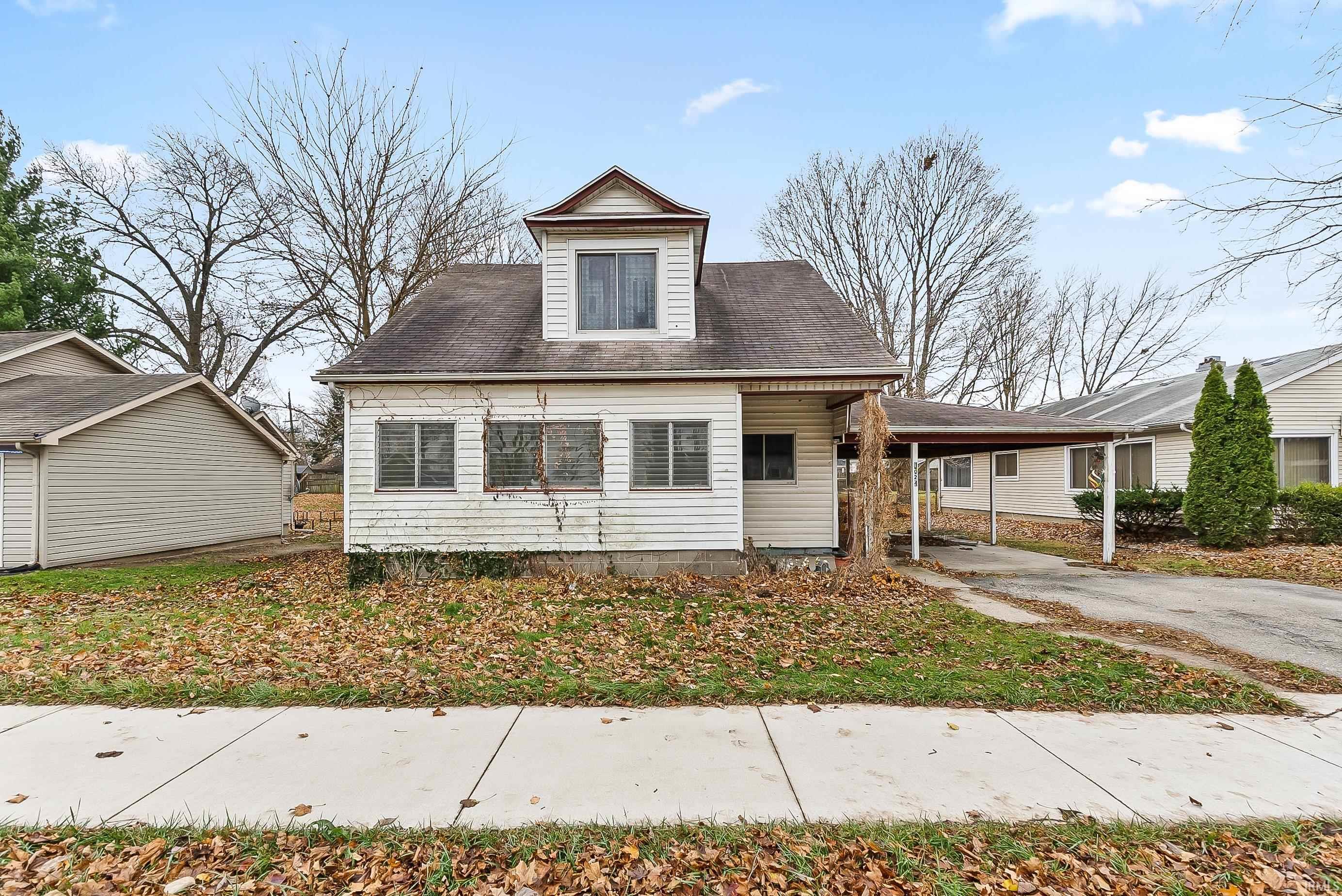 Image 0: View of front facade featuring an attached carport, driveway, and a porch, Front Of Structure Image 0: View of front facade featuring an attached carport, driveway, and a porch, Front Of Structure