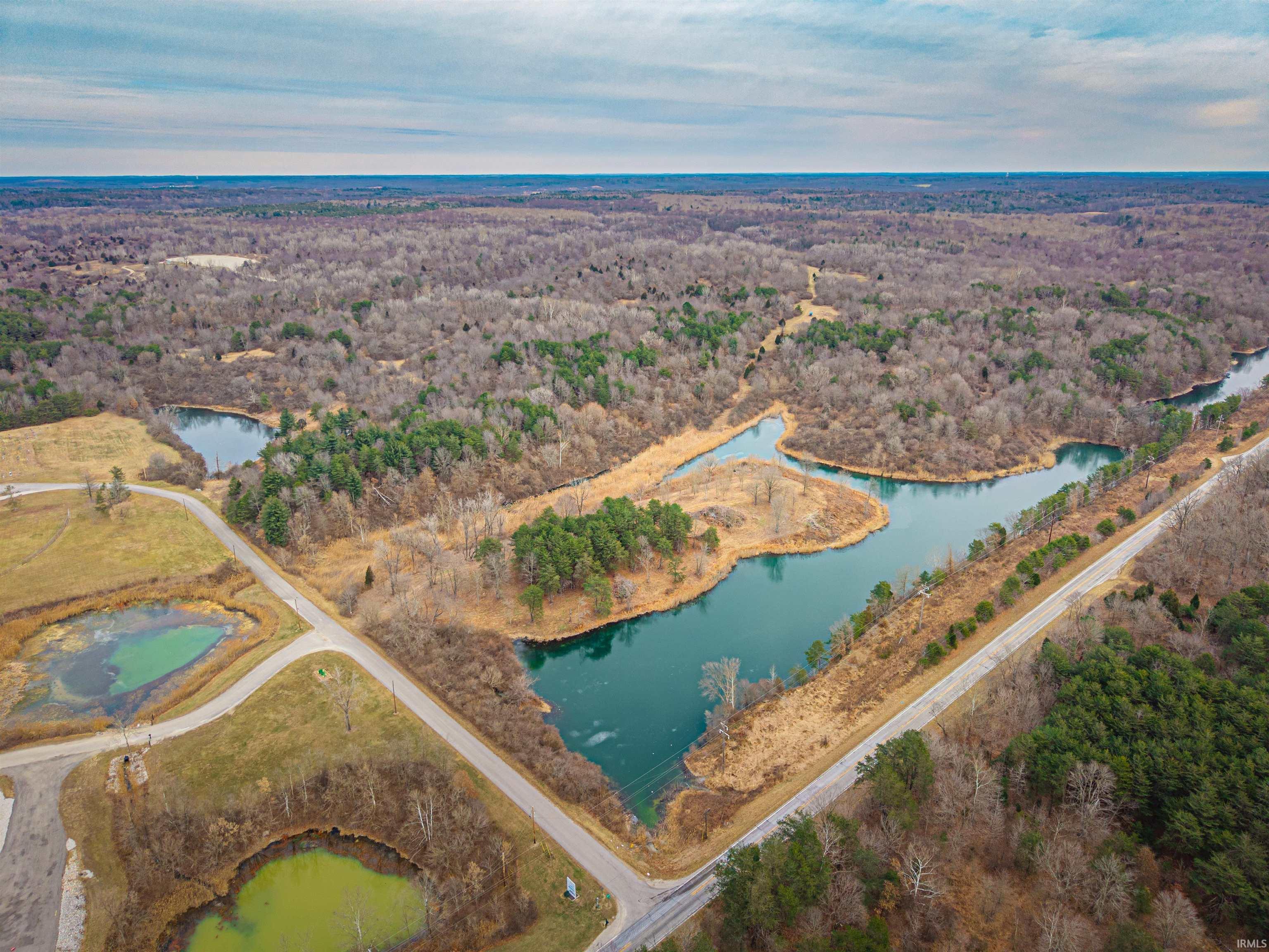 Image 0: Drone / aerial view of a heavily wooded area and a large body of water, Aerial View Image 0: Drone / aerial view of a heavily wooded area and a large body of water, Aerial View