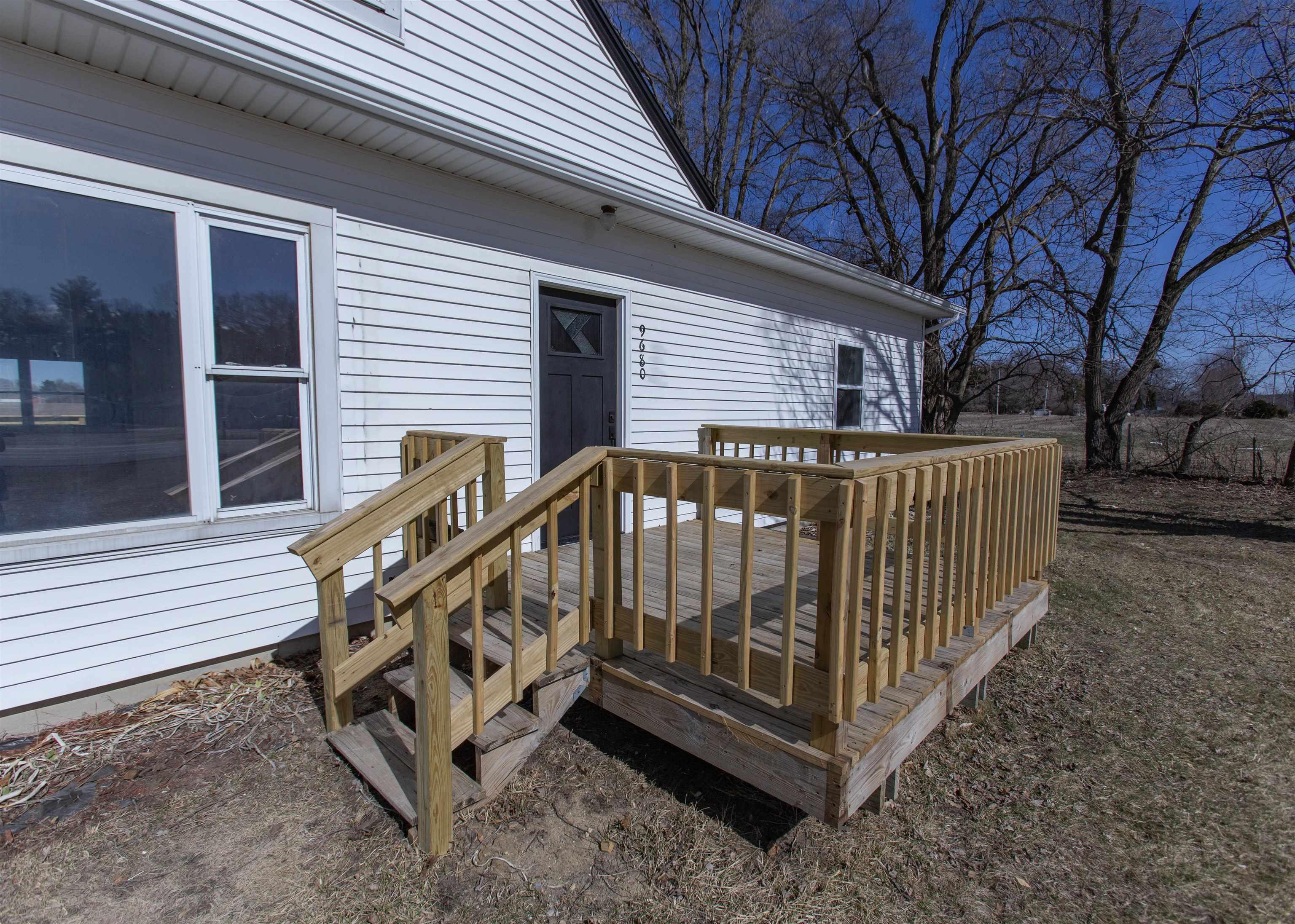 Image 1: Front deck to the entrance into the home
