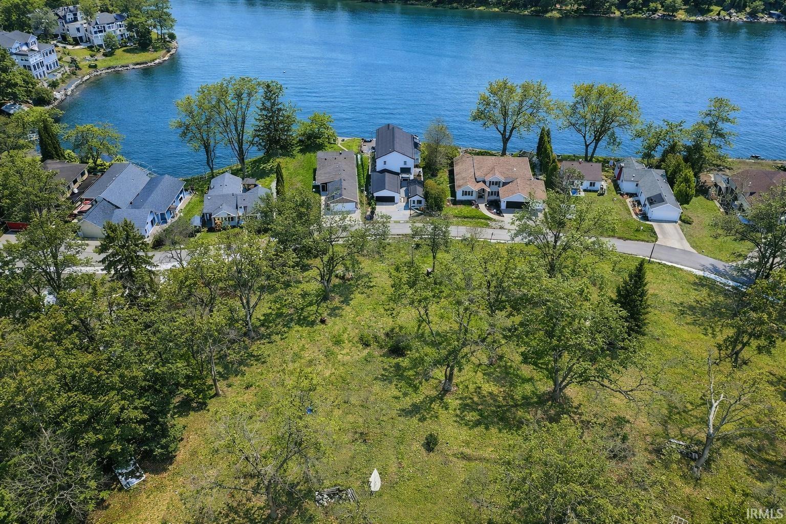 Image 3: Aerial perspective of suburban area featuring a nearby body of water, Aerial View