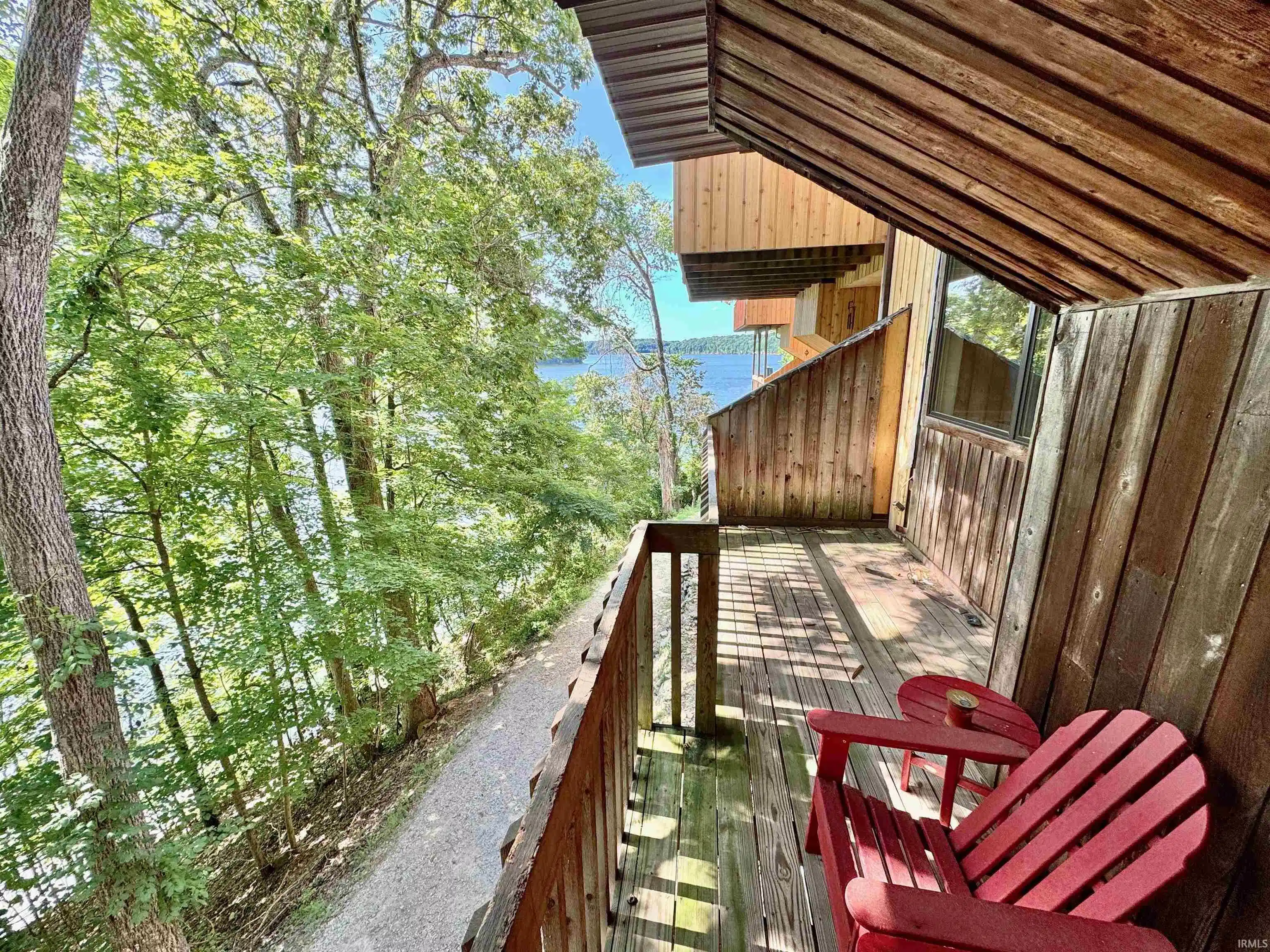 Image 0: Wood-paneled exterior with a private balcony featuring wooden flooring and a wooden railing, Balcony Image 0: Wood-paneled exterior with a private balcony featuring wooden flooring and a wooden railing, Balcony