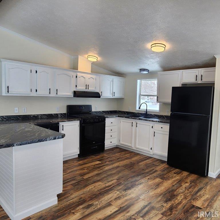 Image 2: Kitchen with white cabinetry, a textured ceiling, black appliances, vaulted ceiling, and a peninsula, Kitchen Image 2: Kitchen with white cabinetry, a textured ceiling, black appliances, vaulted ceiling, and a peninsula, Kitchen