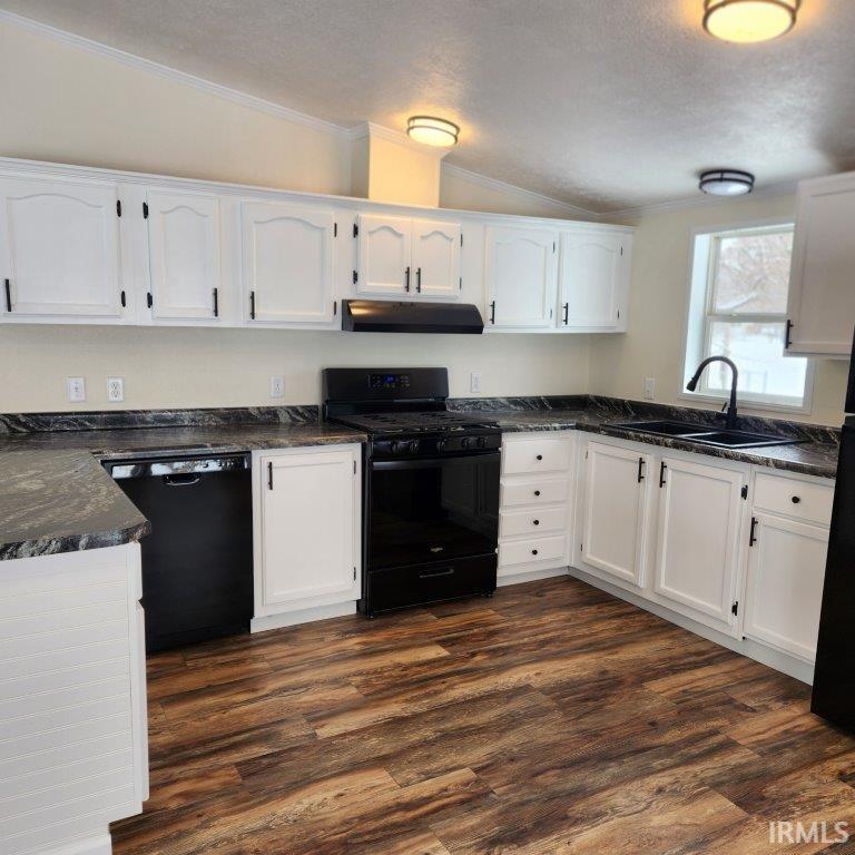 Image 3: Kitchen featuring ornamental molding, white cabinetry, black appliances, dark wood-style flooring, and under cabinet range hood, Kitchen Image 3: Kitchen featuring ornamental molding, white cabinetry, black appliances, dark wood-style flooring, and under cabinet range hood, Kitchen