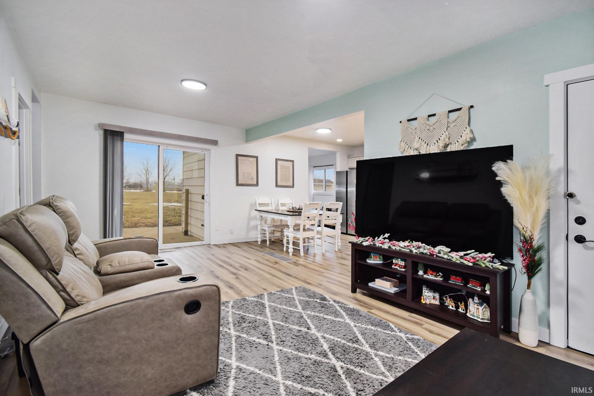 Image 1: Living area with light wood-style floors, Living Room