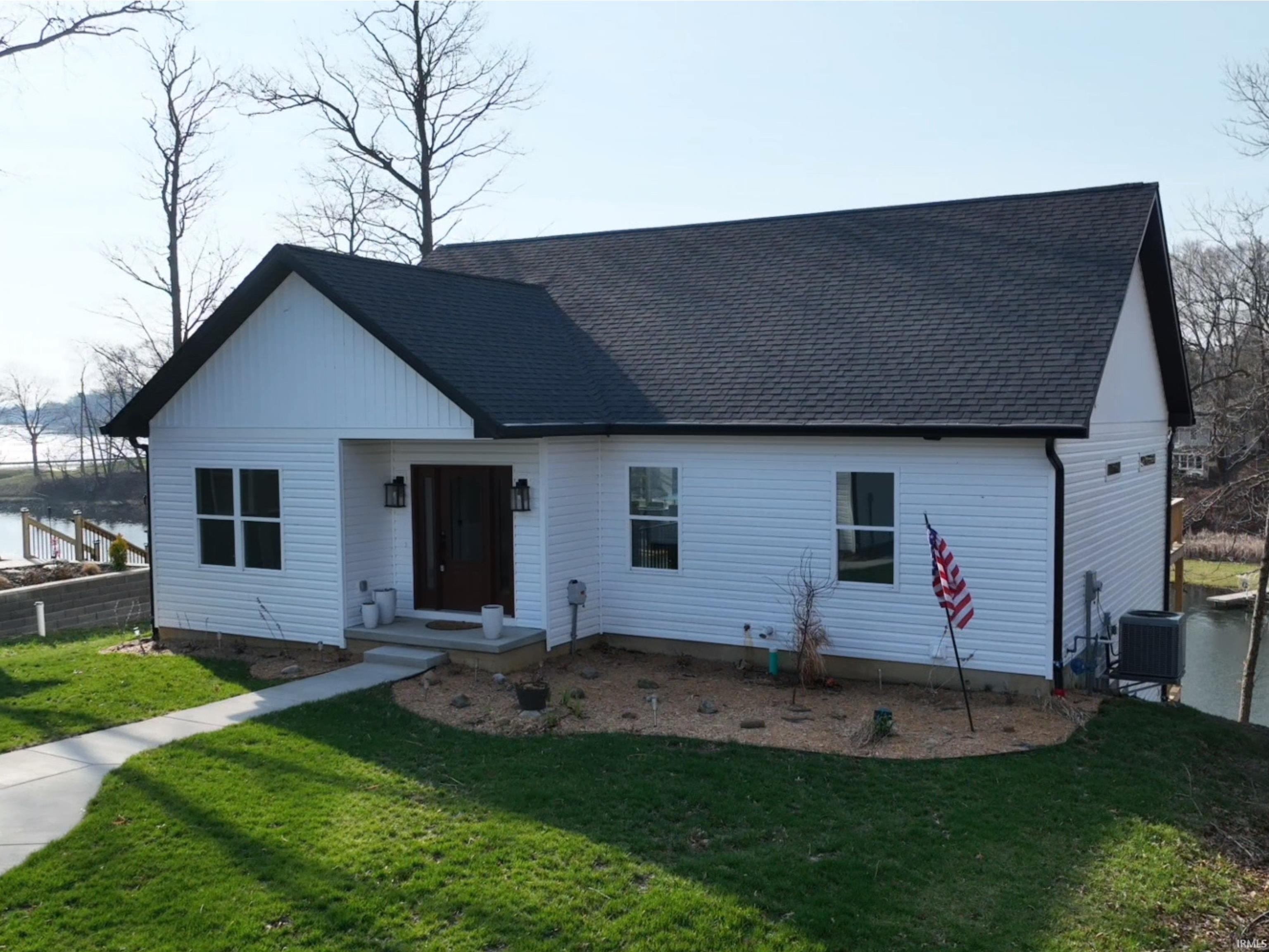Image 0: View of front of property with roof with shingles and a front lawn, Front Of Structure