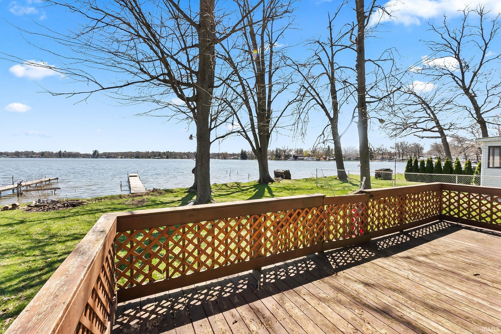 Image 3: Deck featuring a water view and a lawn, Deck