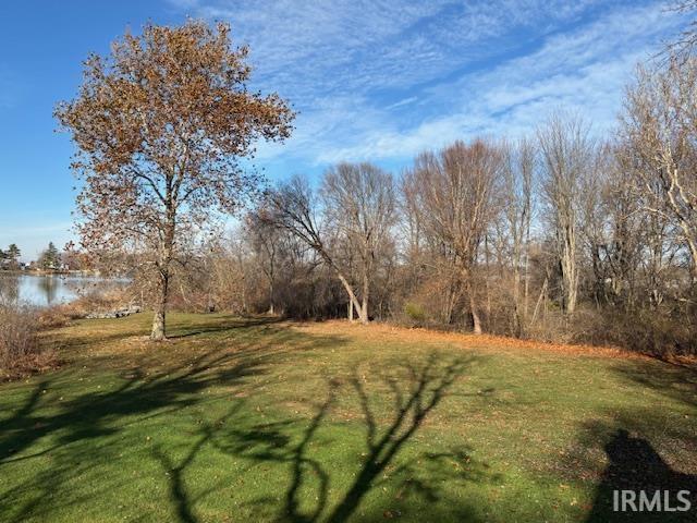 Image 1: View of grassy yard featuring a water view, Yard