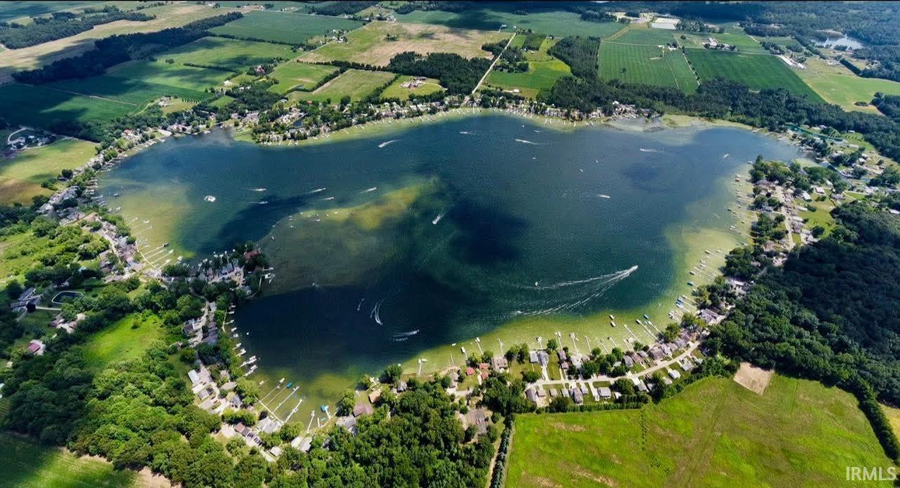 Image 1: Expansive lake surrounded by residential properties and green landscapes, Aerial View Image 1: Expansive lake surrounded by residential properties and green landscapes, Aerial View