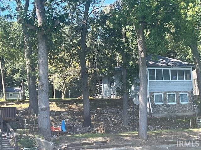 Image 2: View of side of home with a sunroom, Side Of Structure Image 2: View of side of home with a sunroom, Side Of Structure