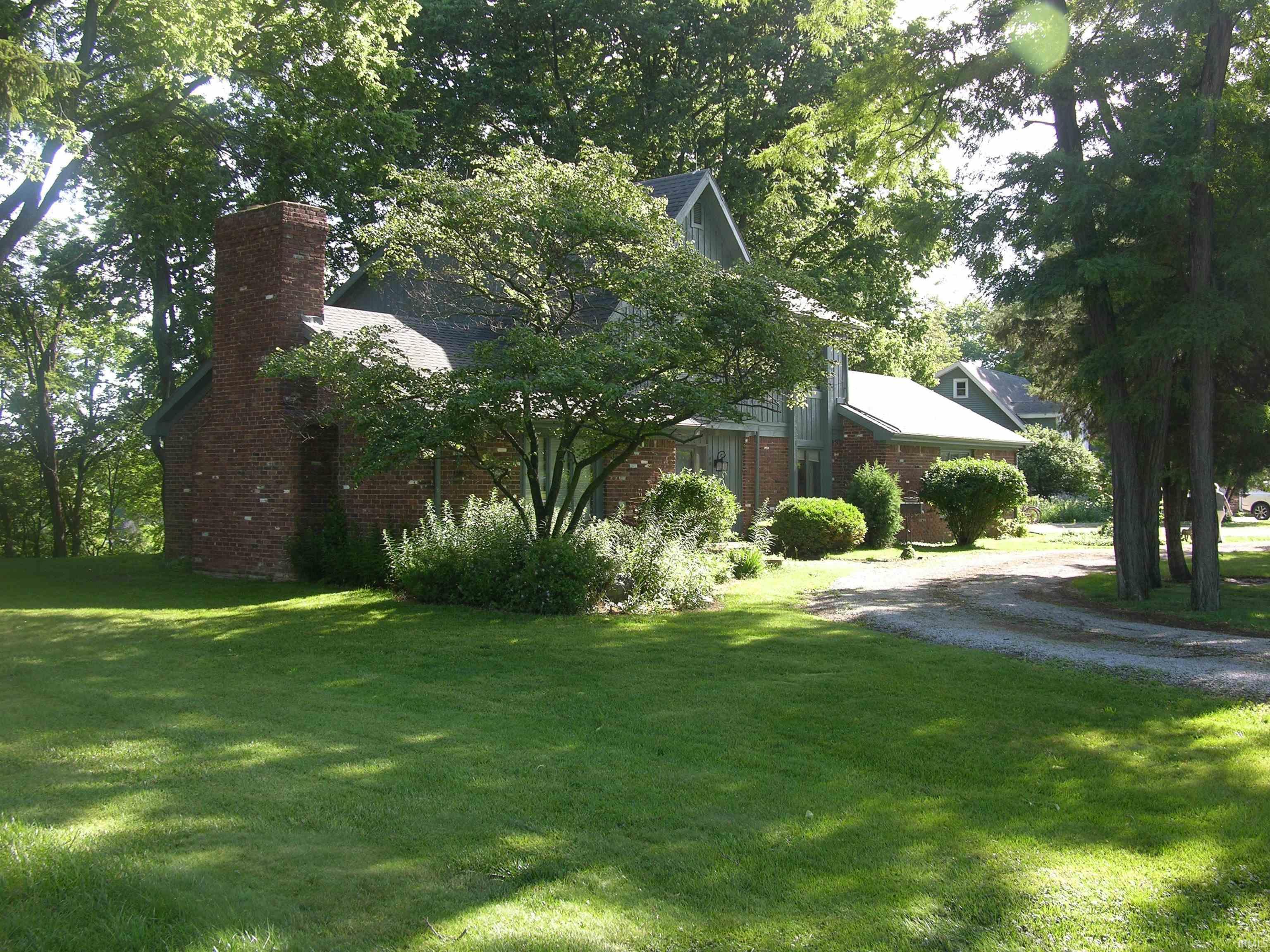 Image 1: Brick and vertical siding exterior with an asphalt shingle roof, Front Of Structure Image 1: Brick and vertical siding exterior with an asphalt shingle roof, Front Of Structure