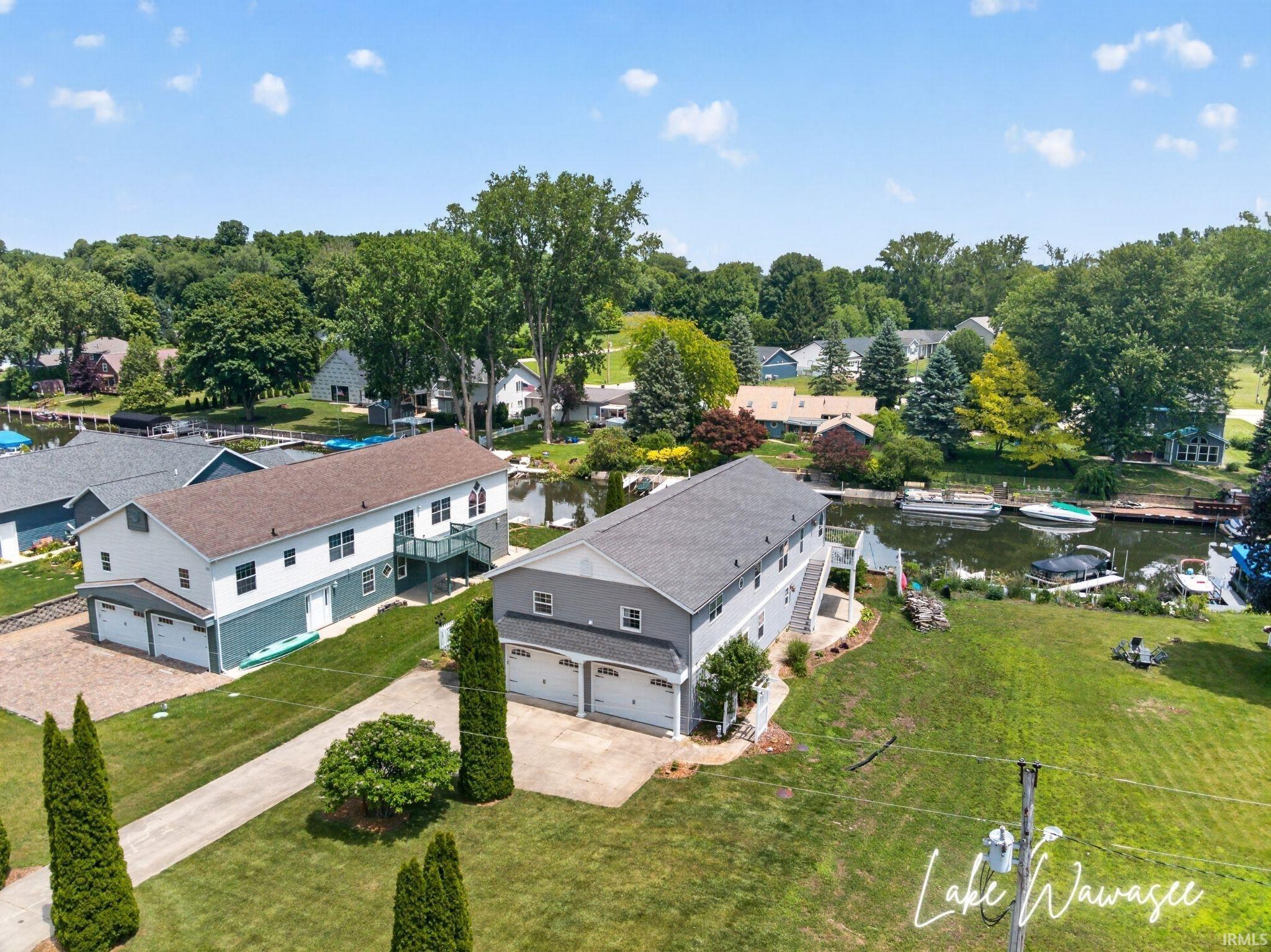 Image 2: Waterfront property featuring two multi-level residences, each with a two-car garage, Aerial View