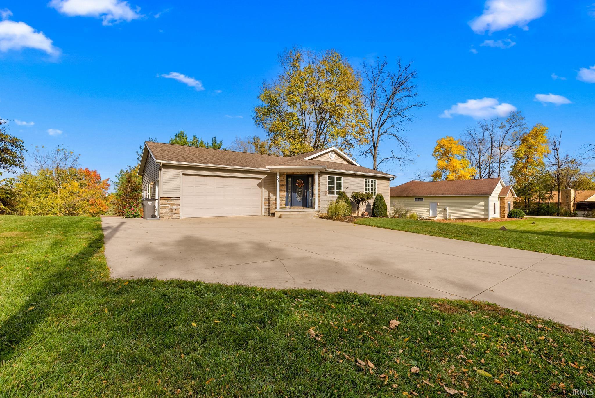 Image 0: Ranch-style home with a front yard, concrete driveway, a garage, and brick siding, Front Of Structure