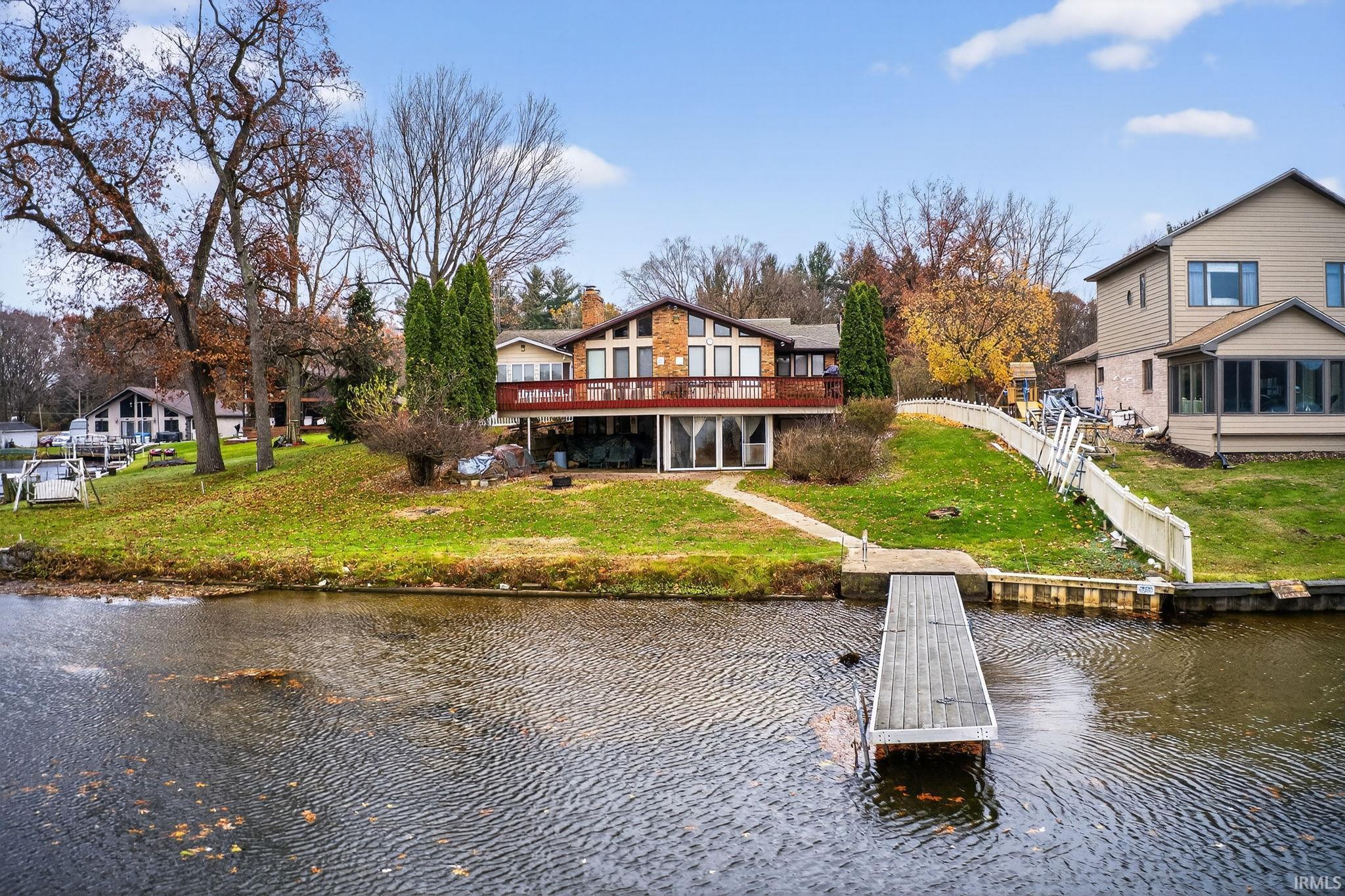 Image 0: Back of property featuring a yard, a water view, and a chimney, Back Of Structure Image 0: Back of property featuring a yard, a water view, and a chimney, Back Of Structure