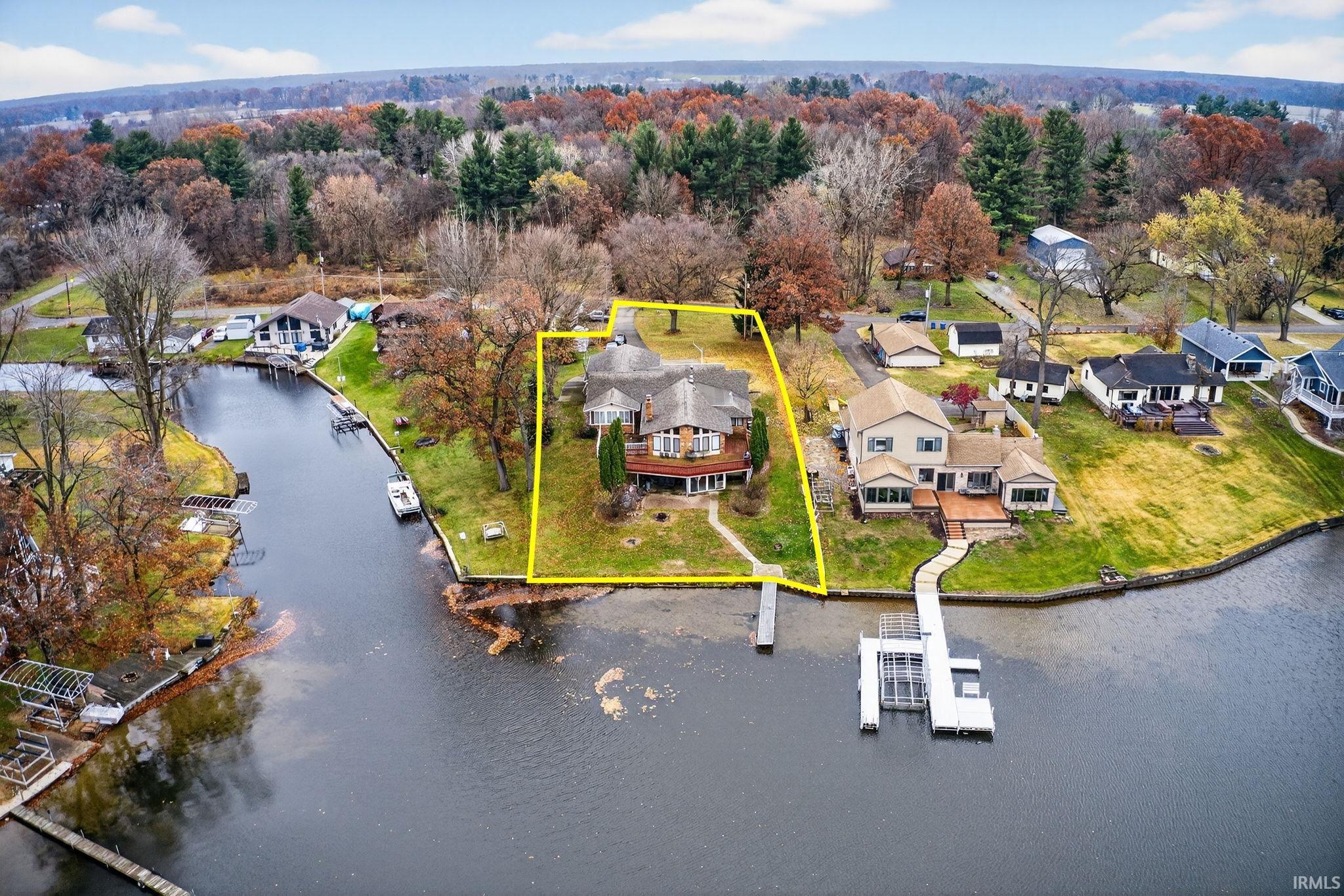 Image 3: Aerial perspective of suburban area with property parcel outlined and a nearby body of water, Aerial View Image 3: Aerial perspective of suburban area with property parcel outlined and a nearby body of water, Aerial View
