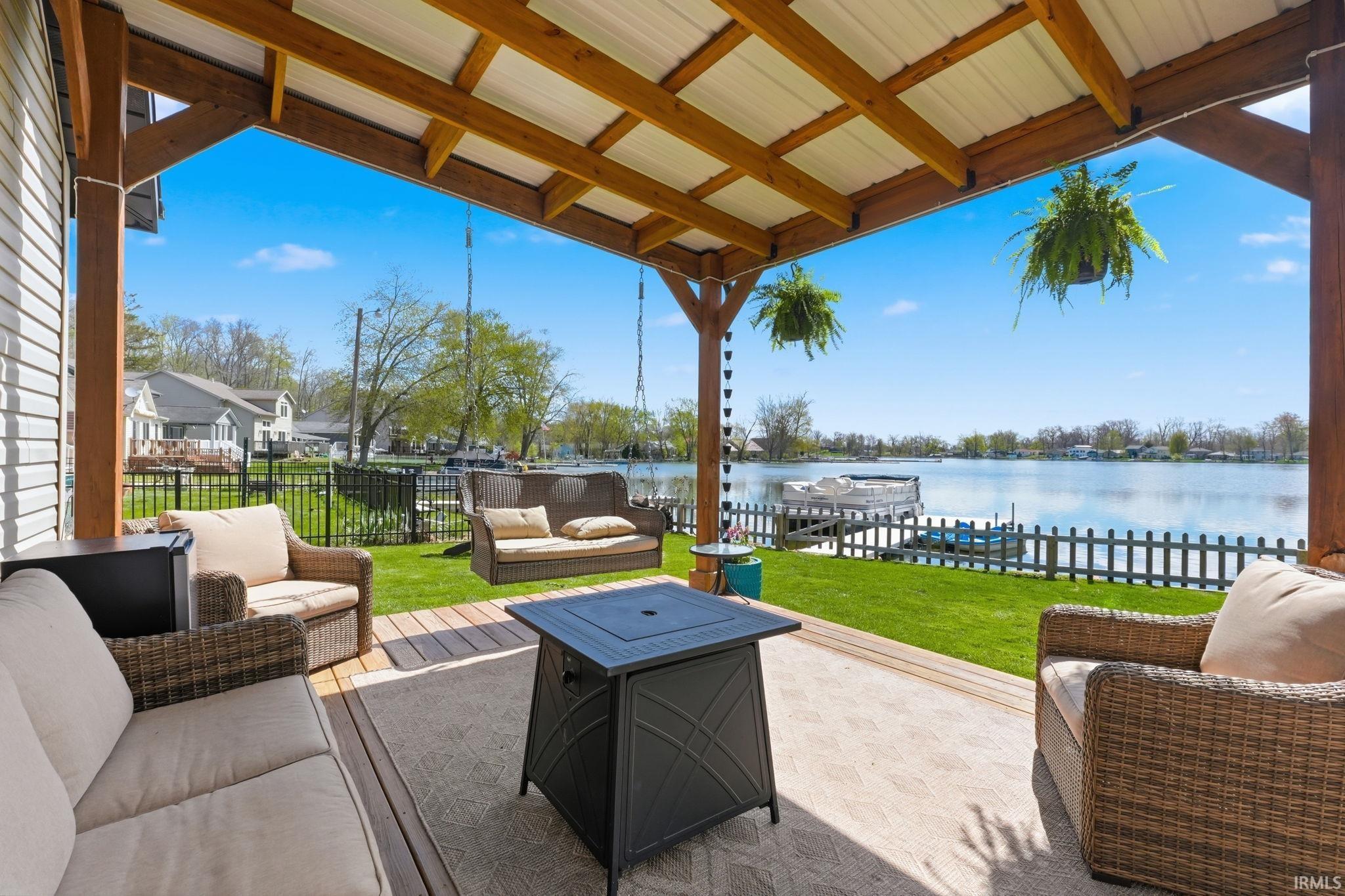 Image 3: View of patio / terrace featuring an outdoor lounge area and a water view, Patio