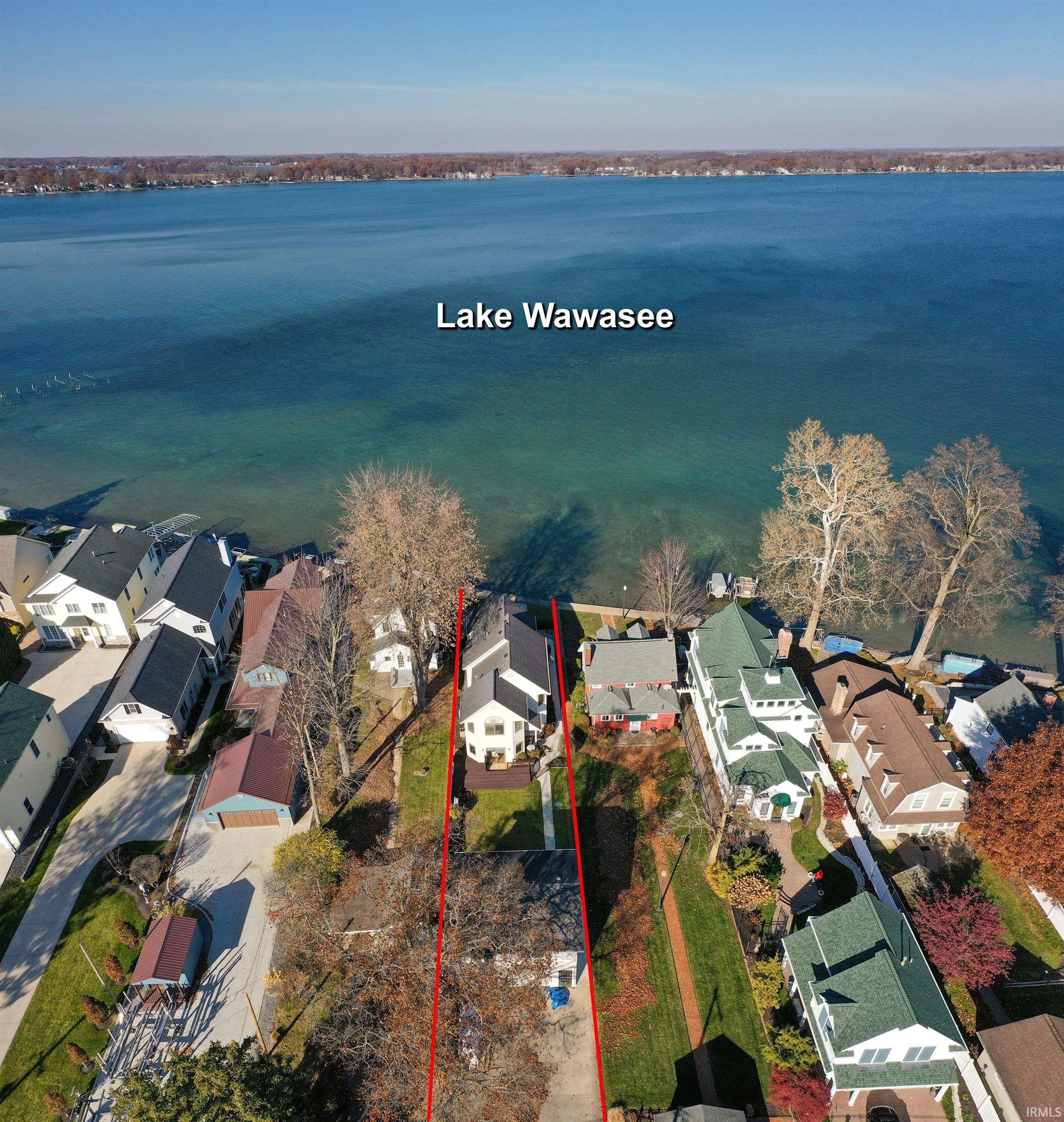Image 0: Aerial view of residential area with a nearby body of water and property boundaries highlighted, Aerial View Image 0: Aerial view of residential area with a nearby body of water and property boundaries highlighted, Aerial View