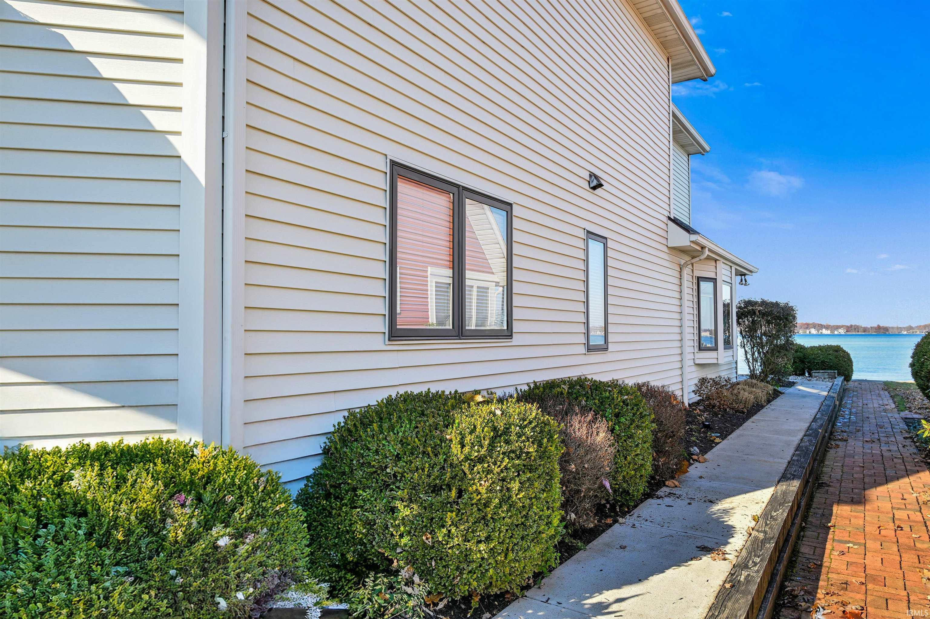 Image 3: View of side of property featuring a water view, Side Of Structure Image 3: View of side of property featuring a water view, Side Of Structure