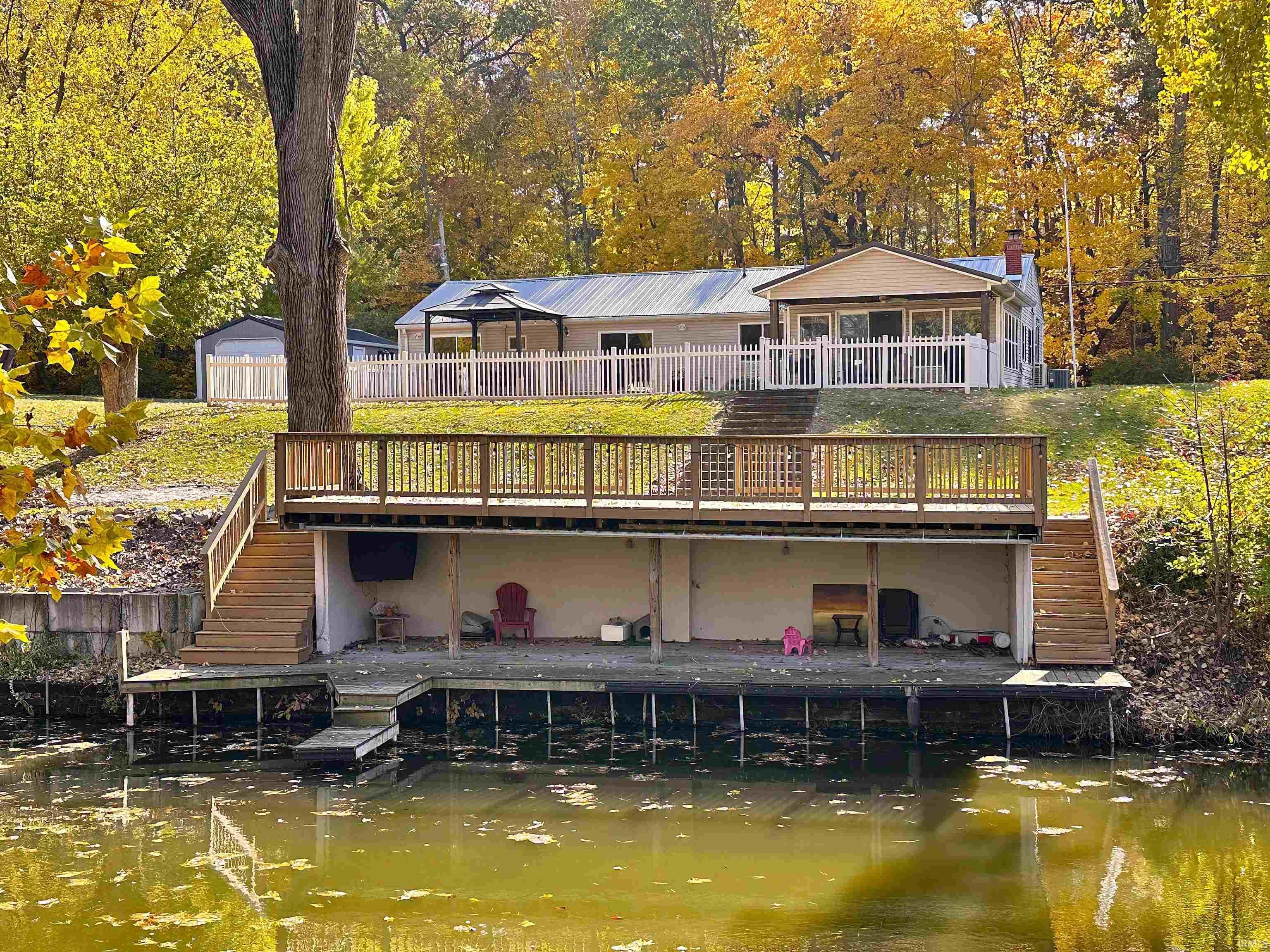 Image 0: Back of house featuring stairs and a wooden deck, Back Of Structure