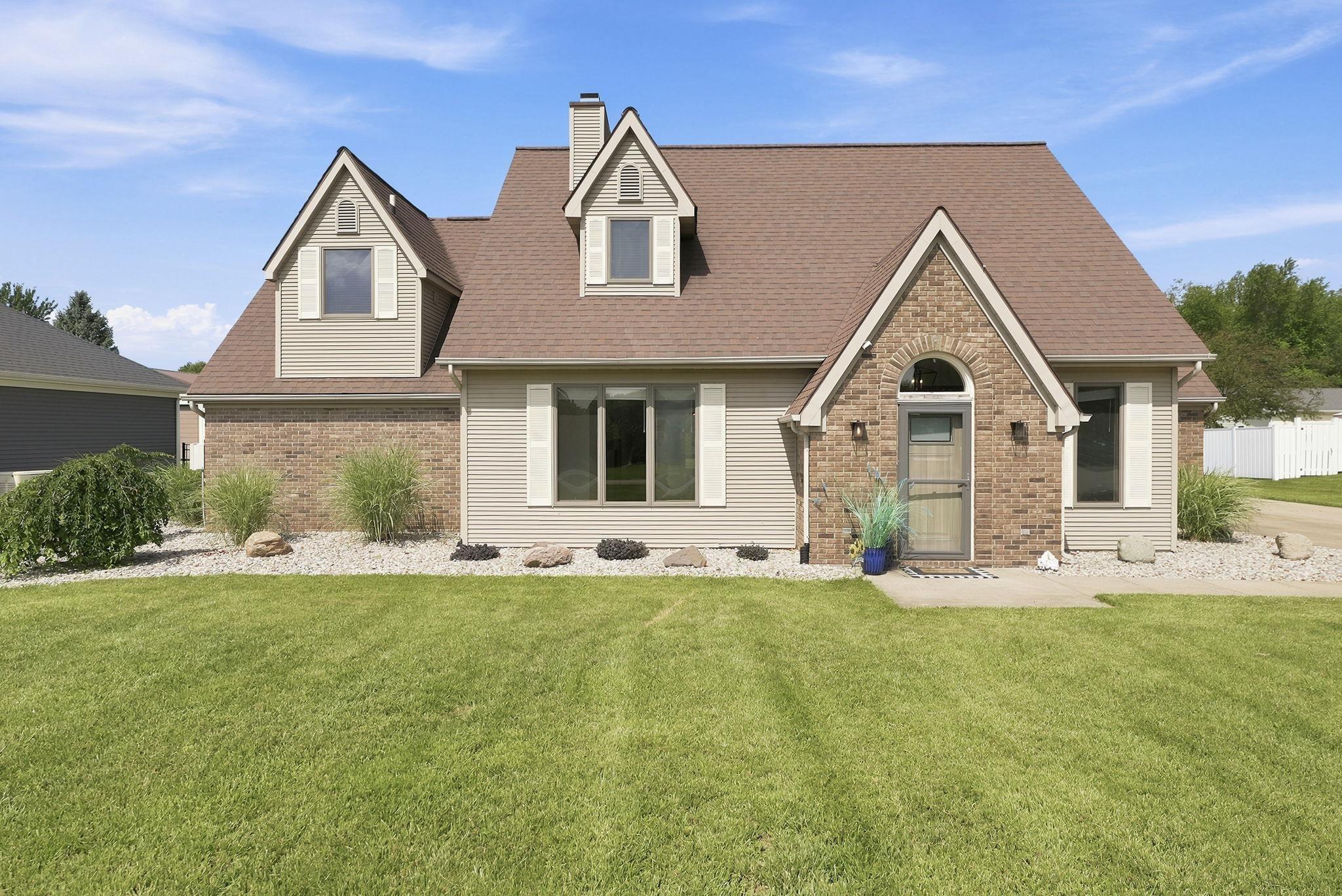 Image 2: Exterior featuring a brick and siding facade with dormer windows, Front Of Structure