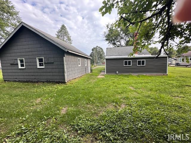 Image 1: Two separate structures featuring gray siding and white-framed windows, Back Of Structure Image 1: Two separate structures featuring gray siding and white-framed windows, Back Of Structure
